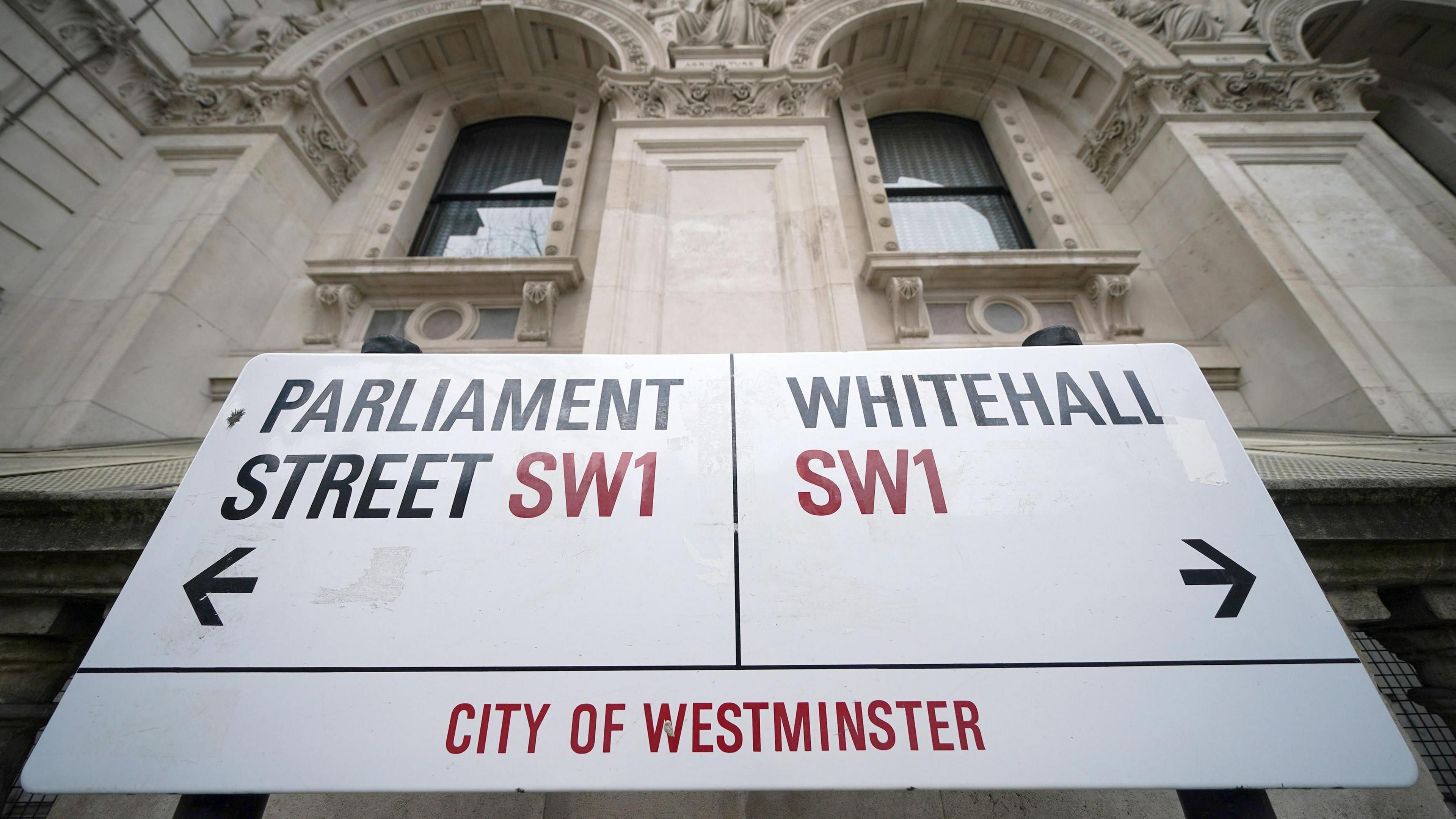 A street sign giving directions to Parliament Street and Whitehall 