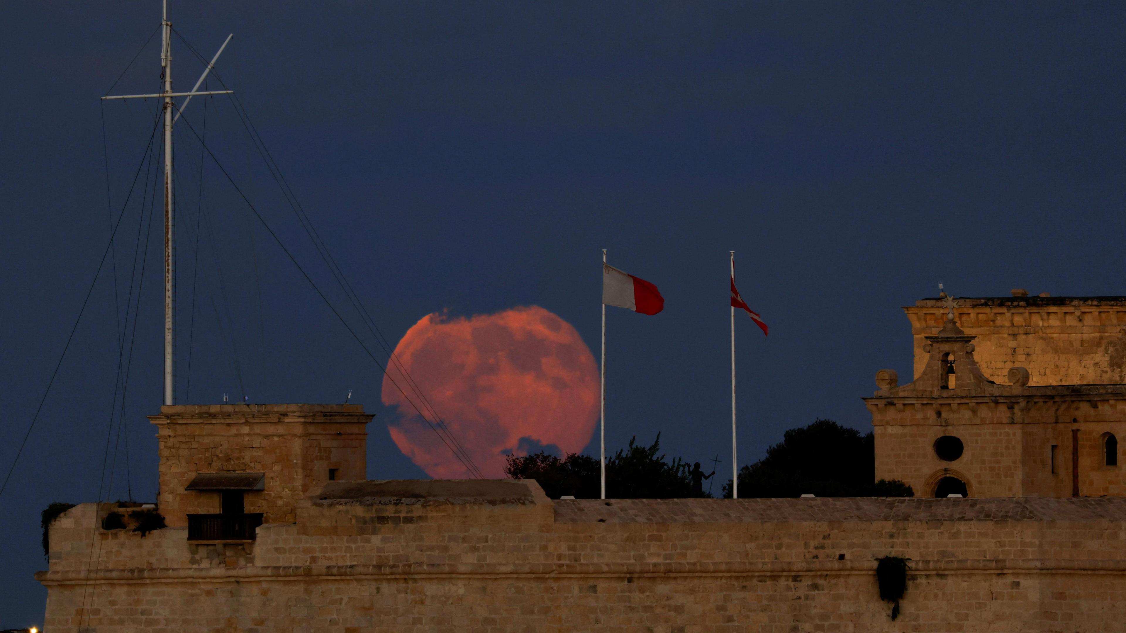 A red Supermoon appears behind a Fort Saint Angelo in Grand Harbour, as seen from Floriana, Malta