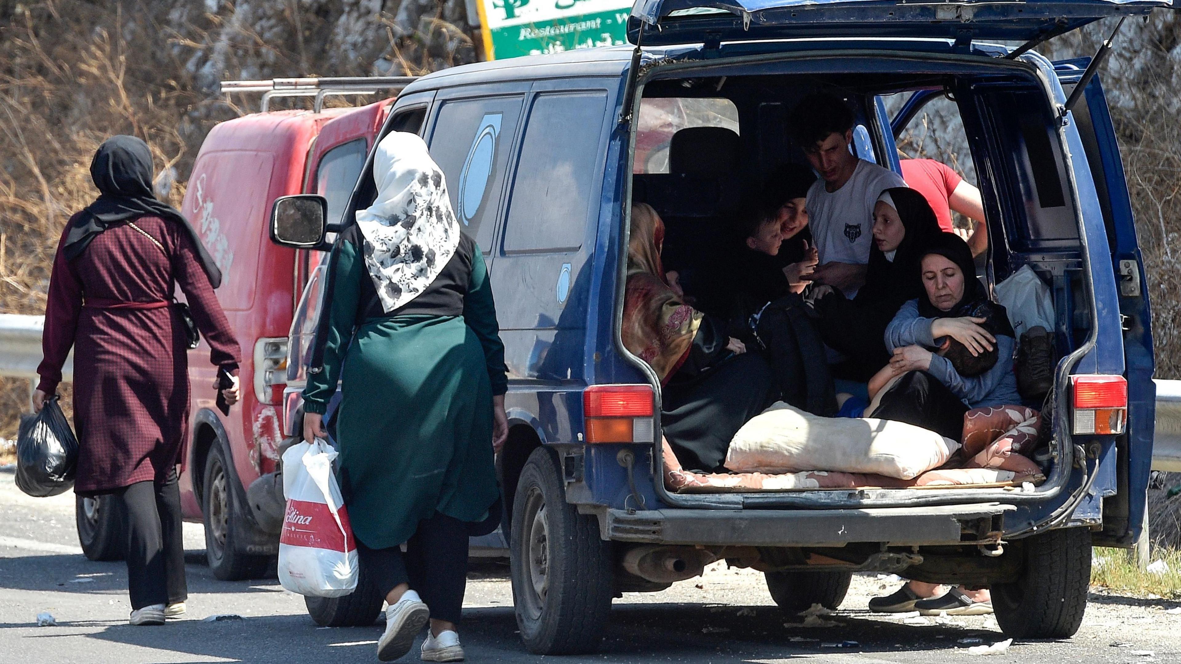 Lebanese people, who are fleeing southern Lebanon, travel with their belongings along the Damour highway towards Beirut, Lebanon, 24 September