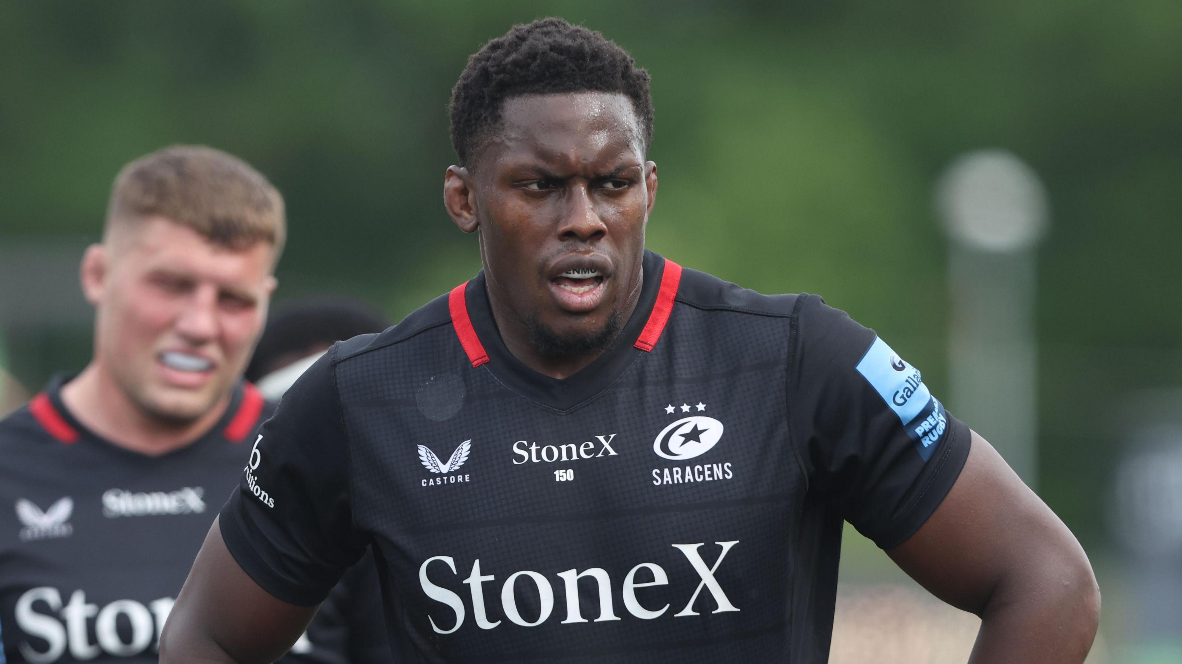 Maro Itoje stands with his hands on his hips