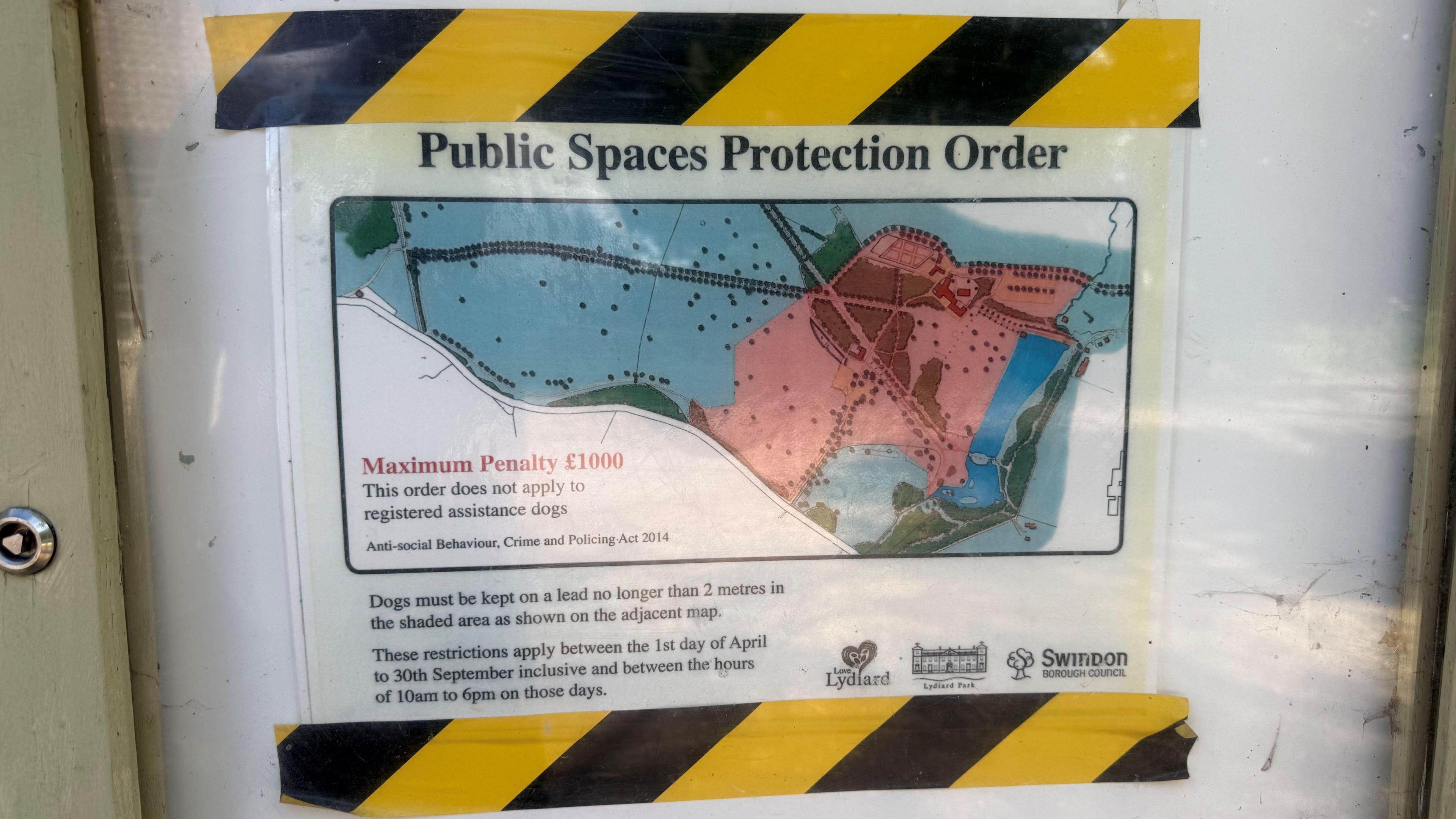 A map of Lydiard Park that has been stuck to a white surface with black and yellow zigzag tape and the words "public spaces protection order" written on it.