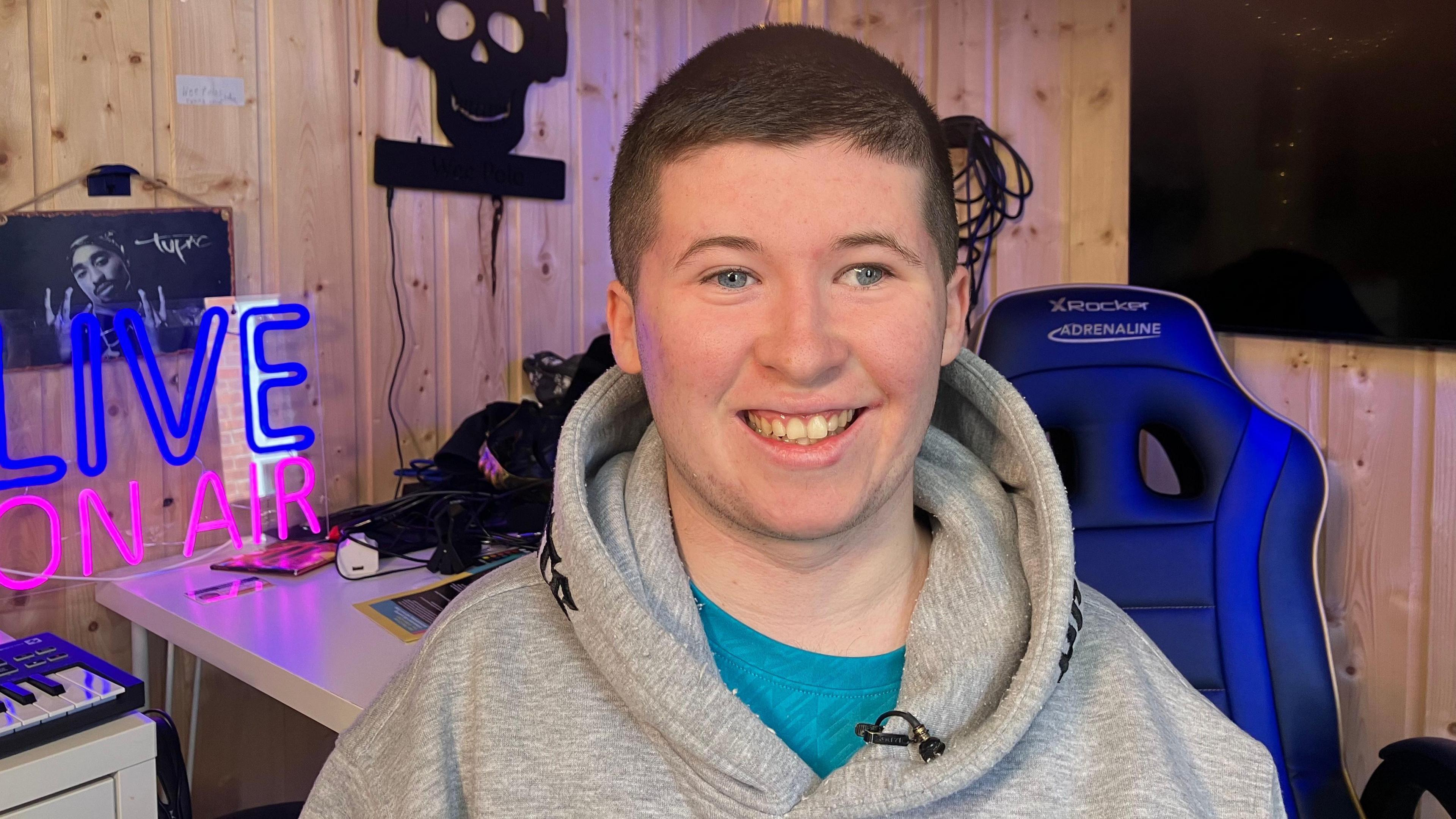 Teenager Conor Bruen smiles at the camera in a grey hoodie. He has brown hair and blue eyes.