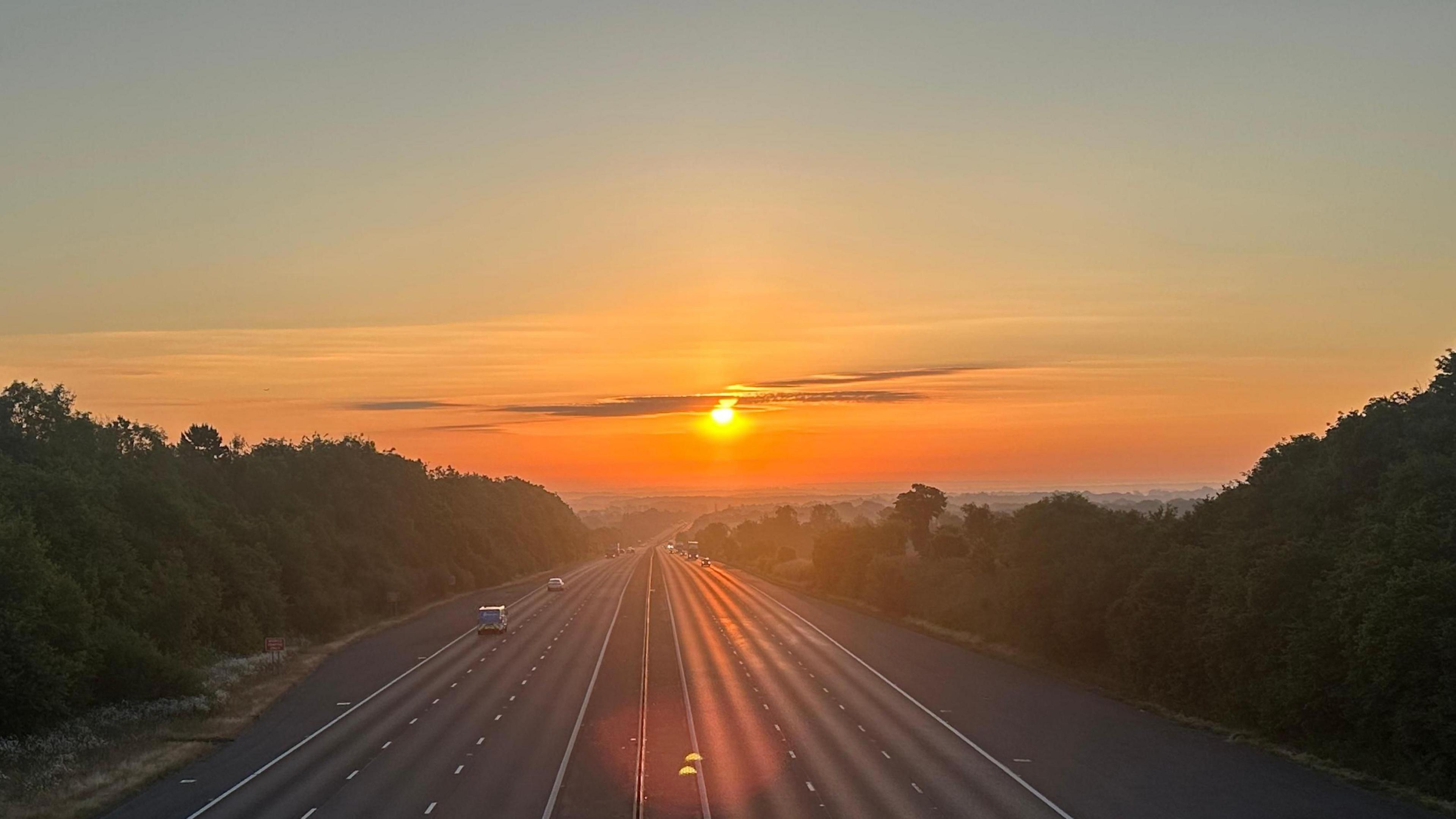 Sun rising over motorway