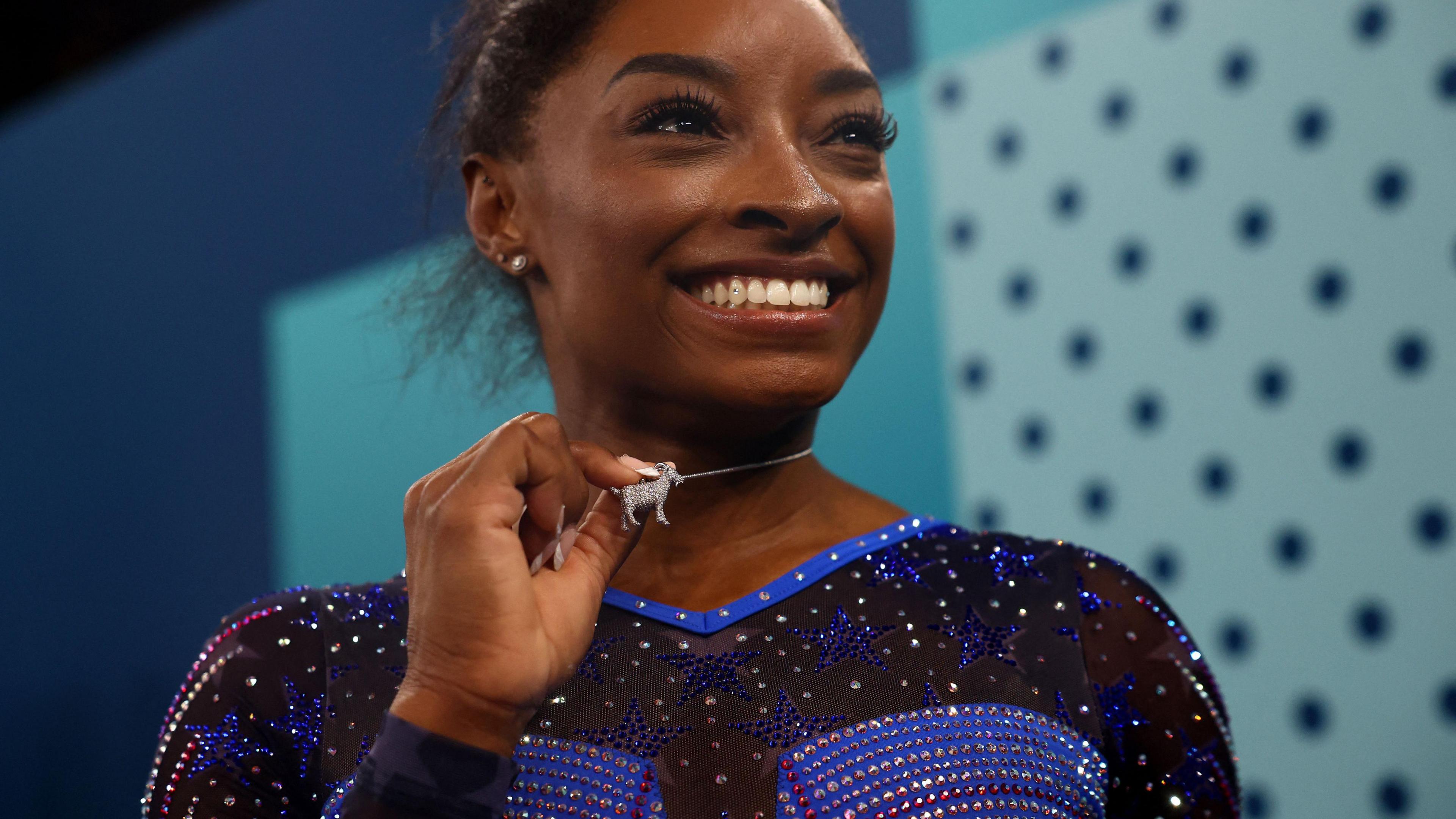 simone biles wearing goat necklace