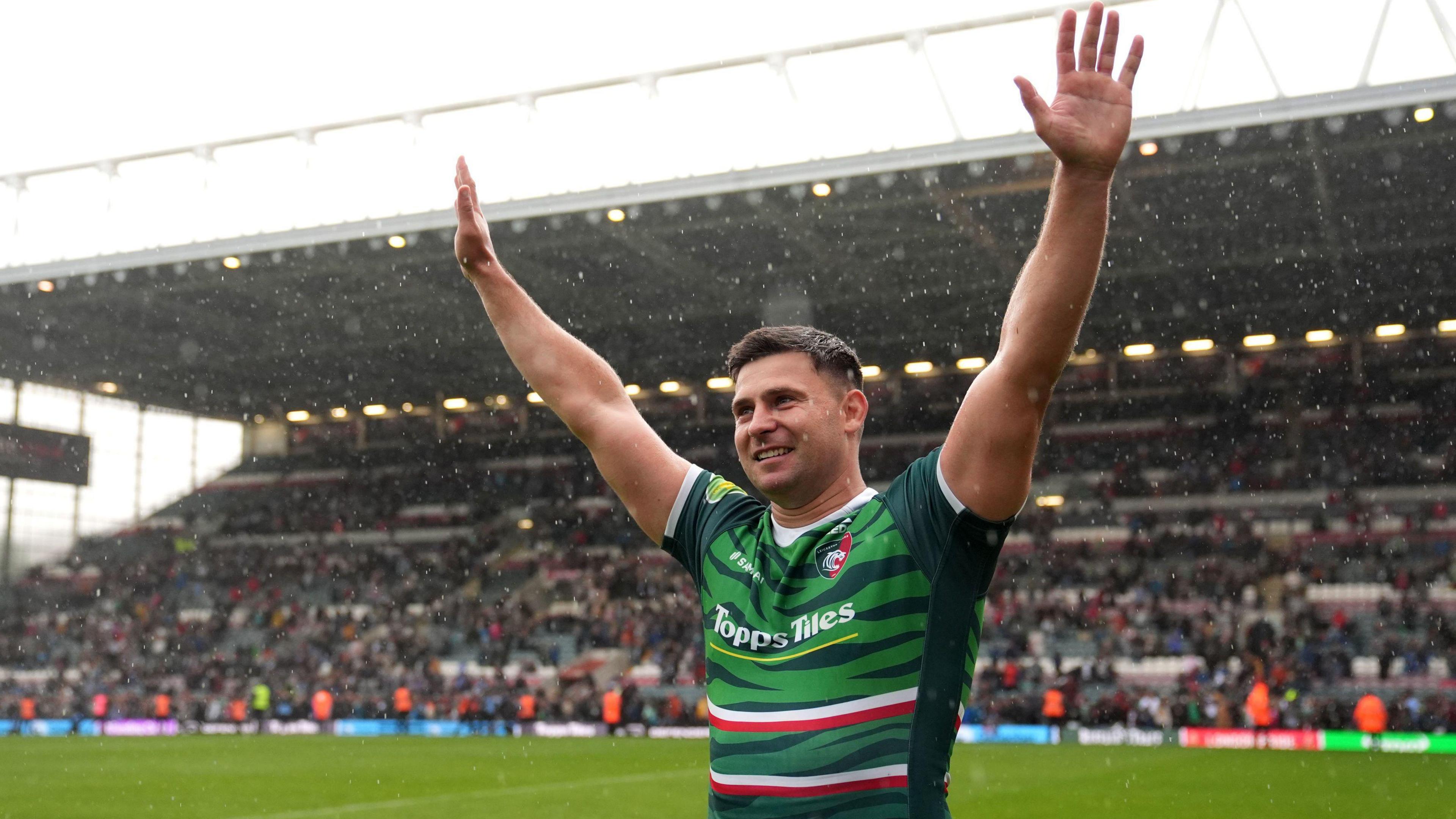 Ben Youngs with his arms up in the air looking jubilant on a rugby pitch. 