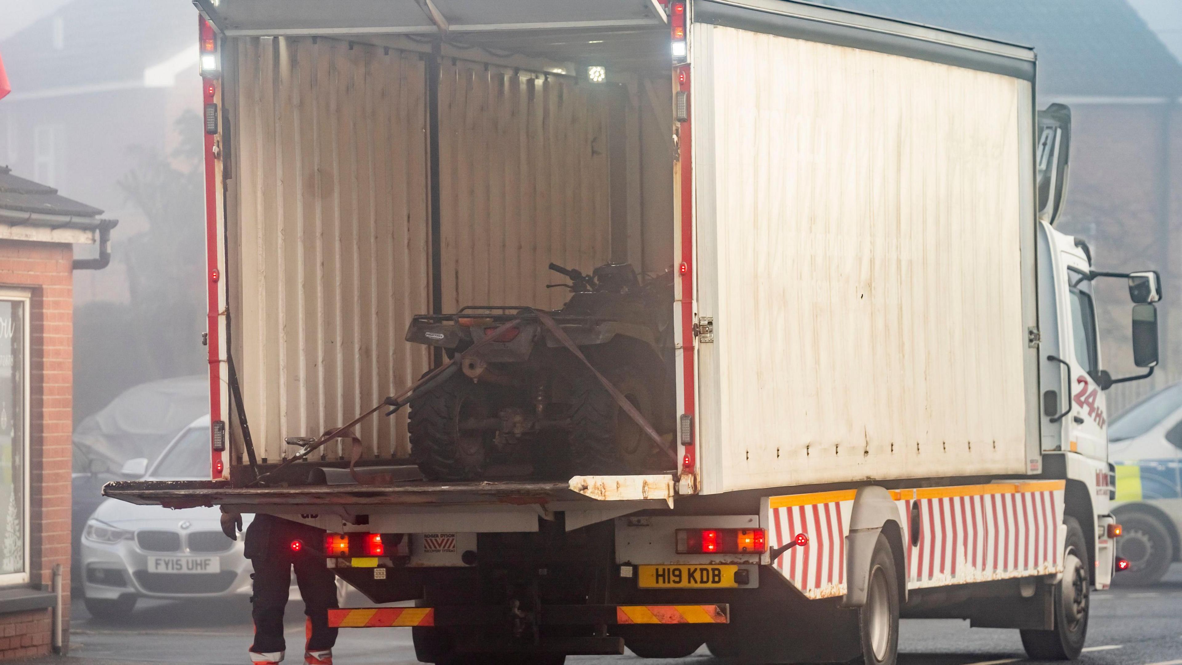 The quad bike in the back of a lorry.