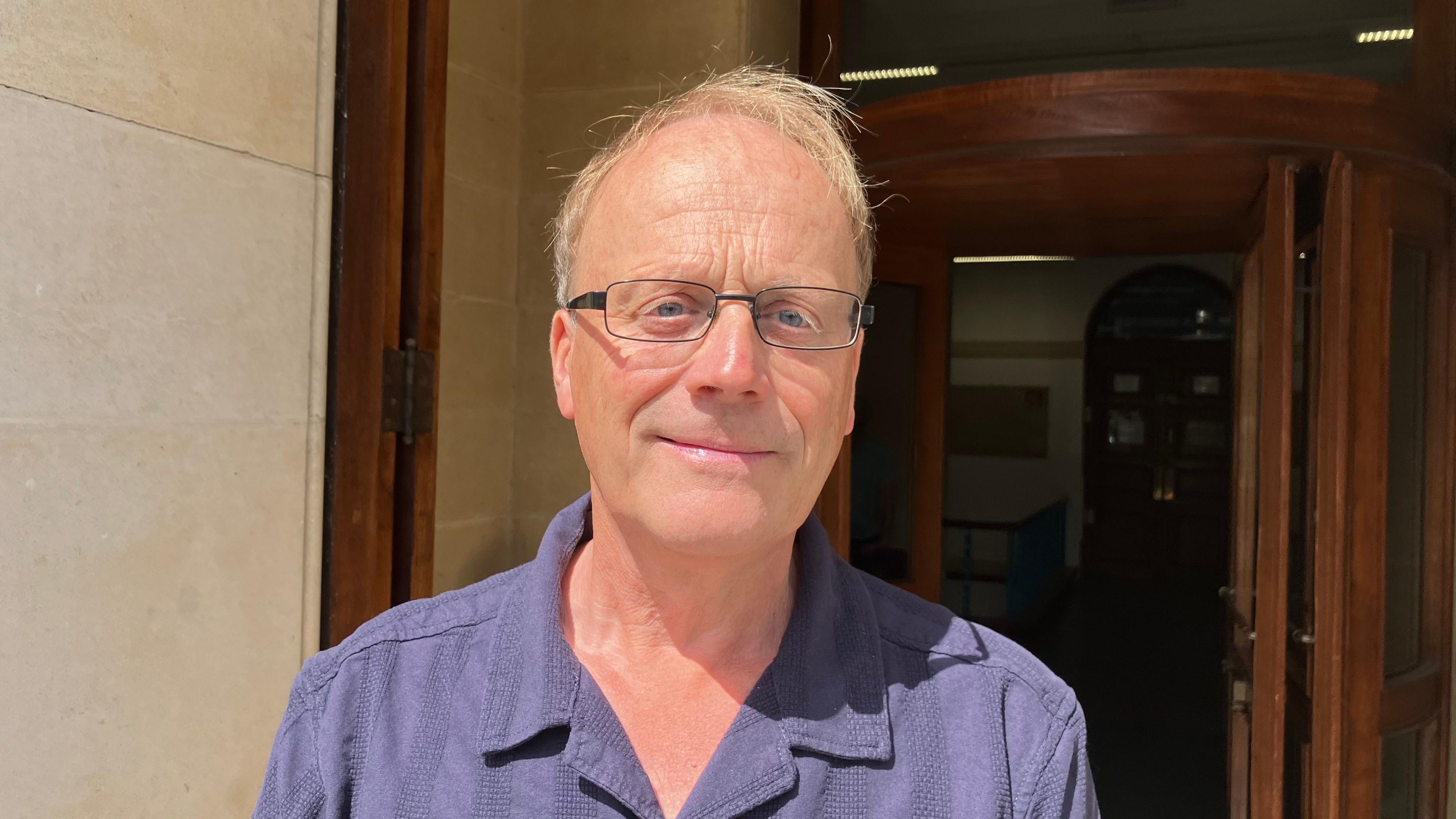 Professor Chris Thornton, standing in front of the Hatherly Laboratories at the University of Exeter
