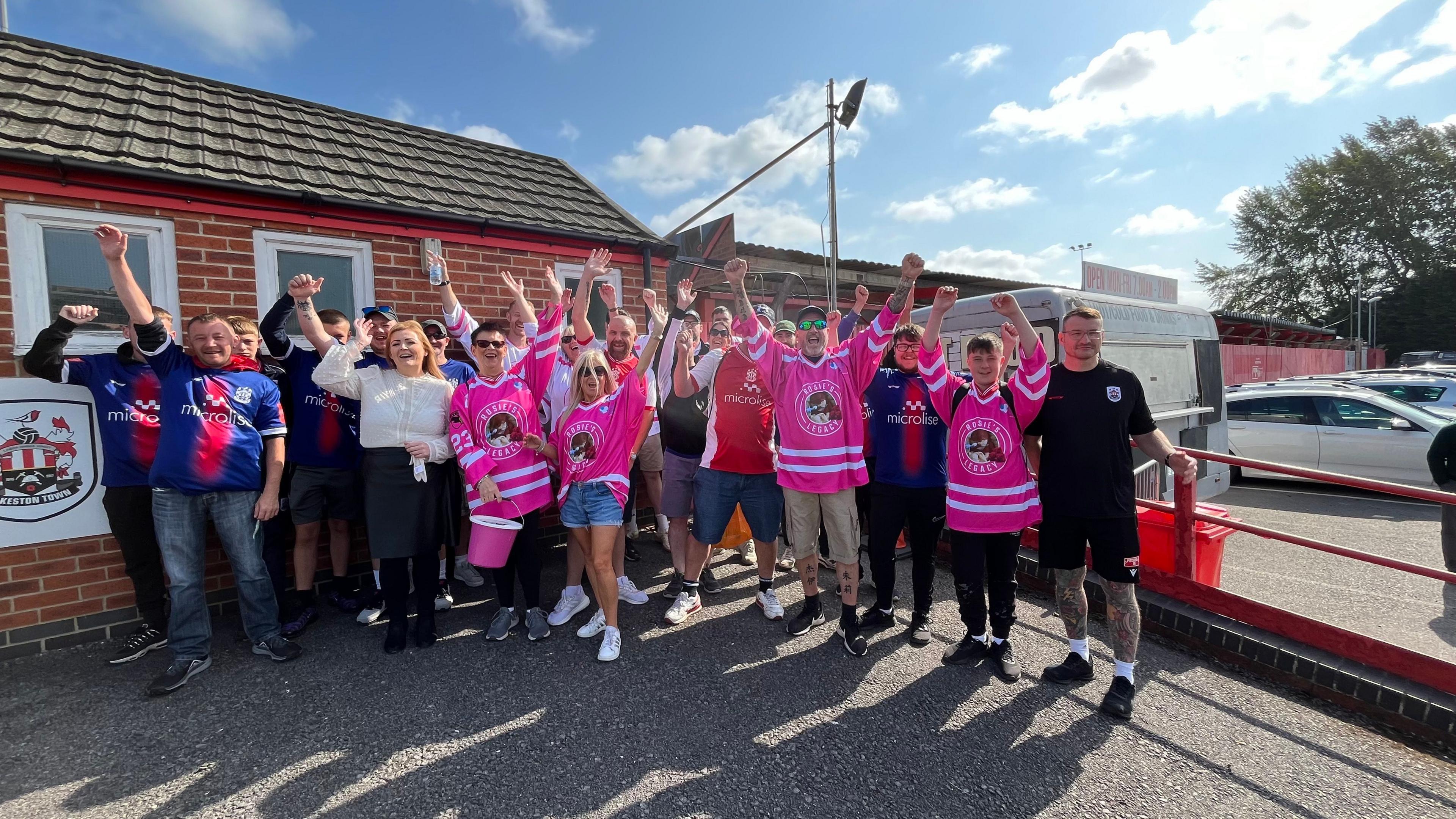 A group cheers before their walk for charity