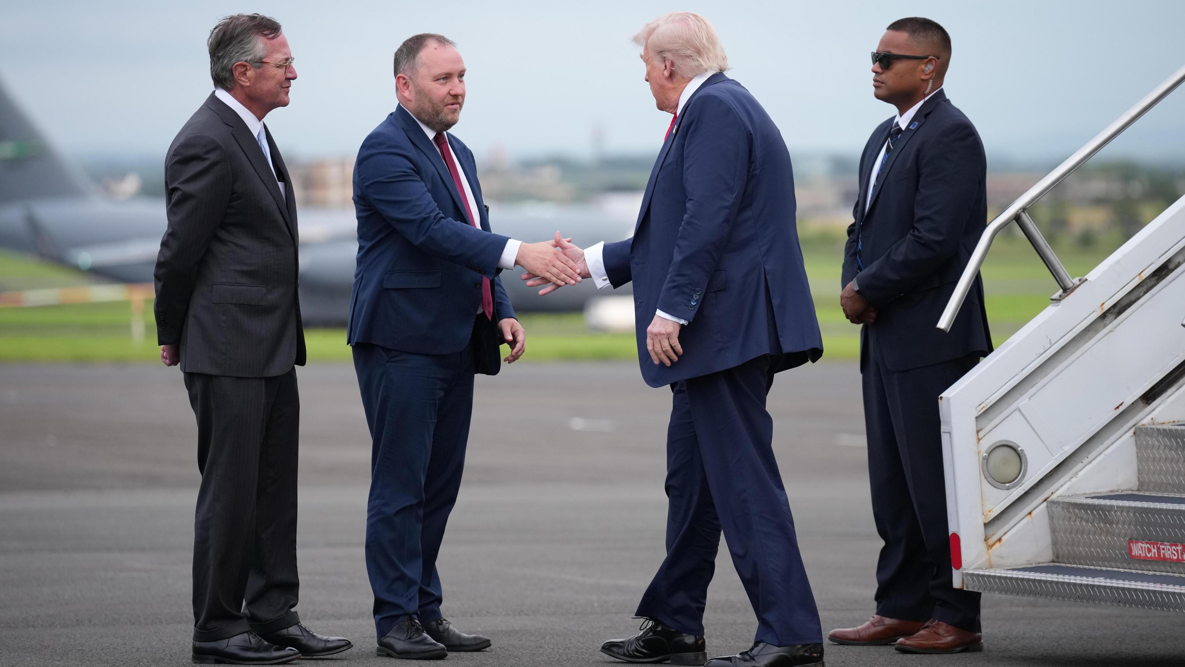 Scottish Secretary Ian Murray greets President Donald Trump, watched by US Ambassador Warren Stephens at Prestwick Airport