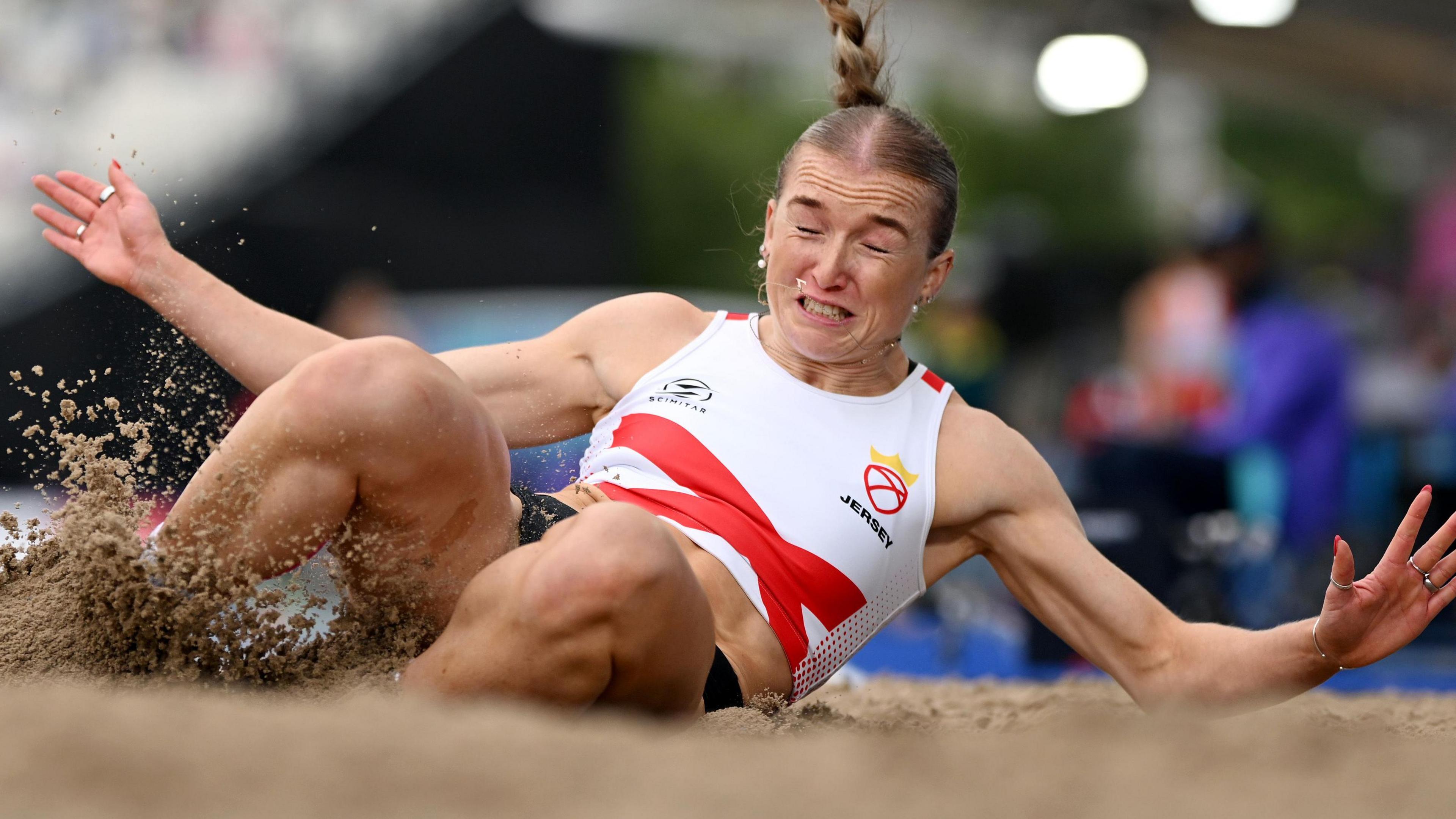 Lucy Woodward jumps into the sand