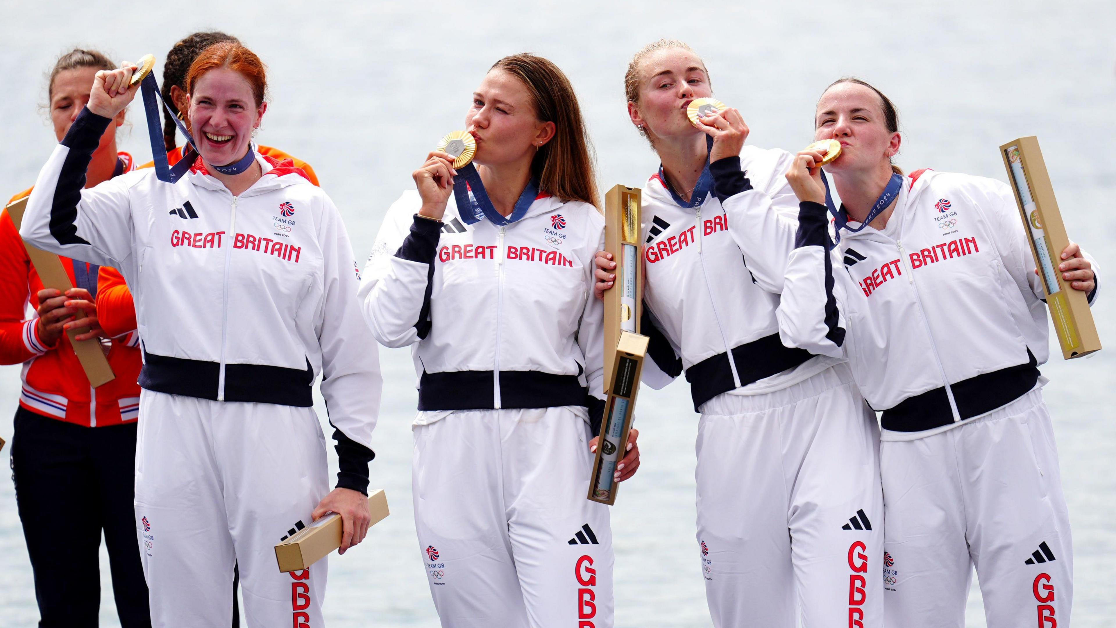 Great Britain’s Lauren Henry, Hannah Scott, Lola Anderson and Georgie Brayshaw celebrate with their gold medals