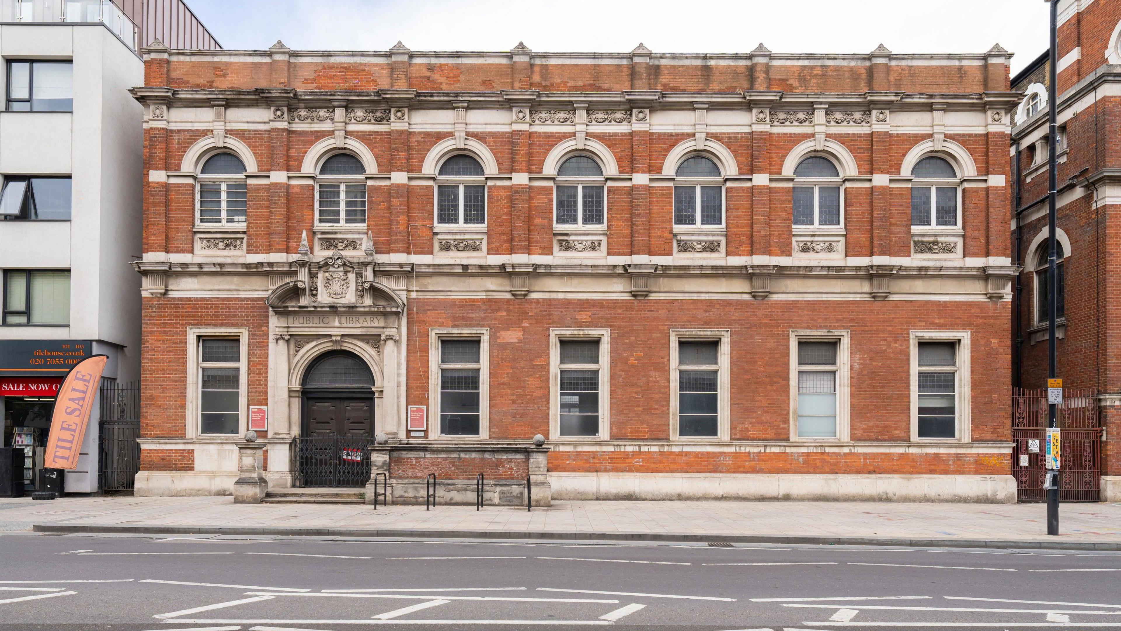 Canning Town Old Library- a red brick Victorian, flat-roofed building with two rows of windows across the facade.