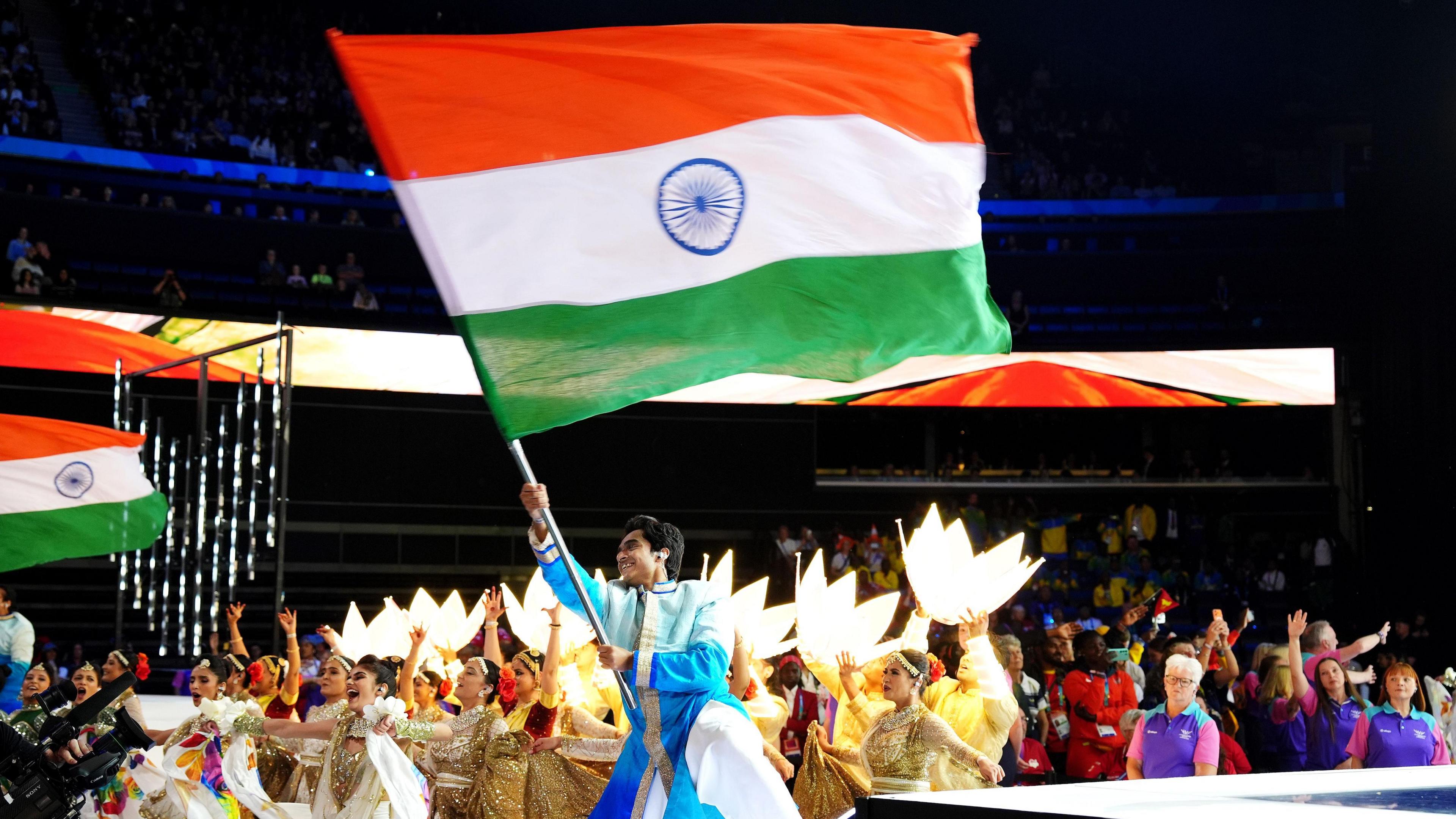 A performer waving the Indian flag