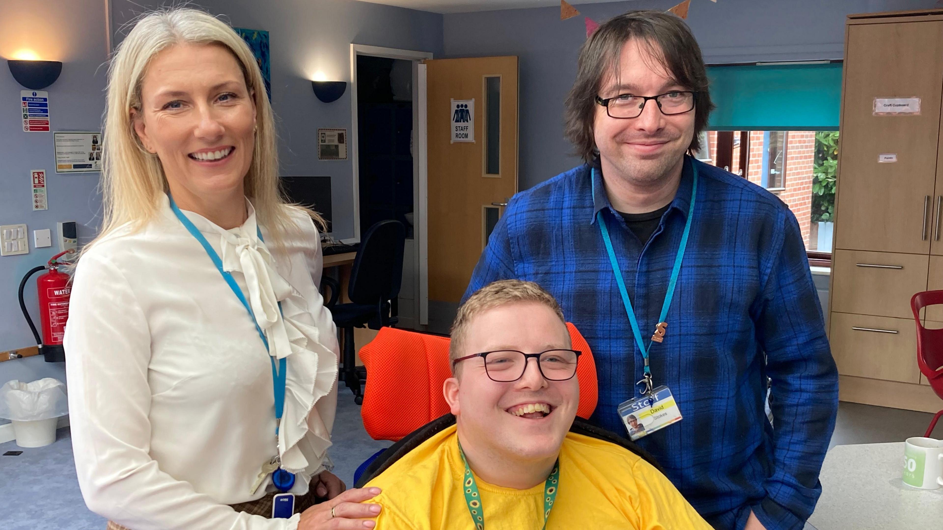 Lynette Barrett with her hand on Xenon's shoulder, with carer David Stokes standing next to him.