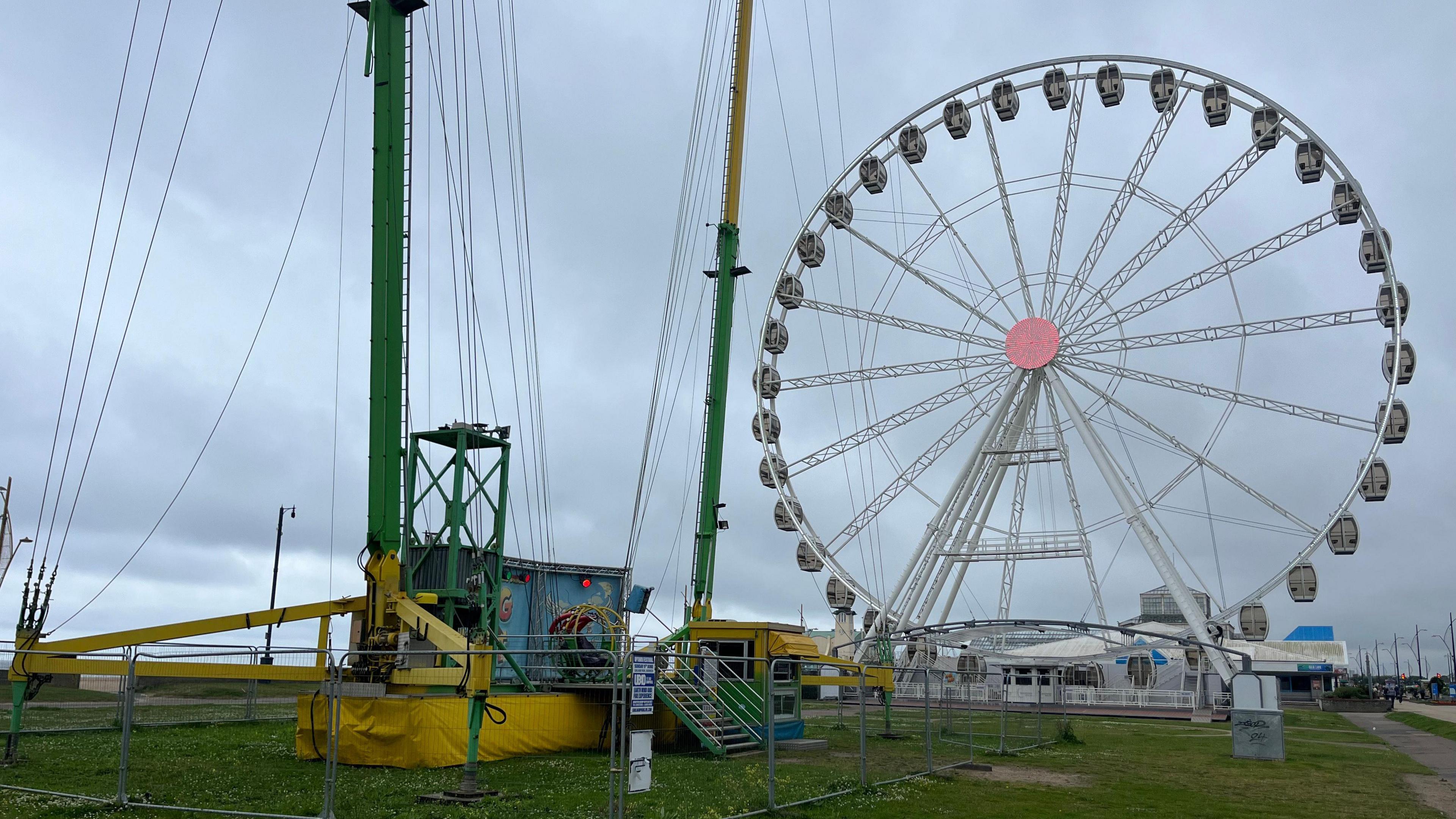 The Slingshot ride with observation wheel behind it