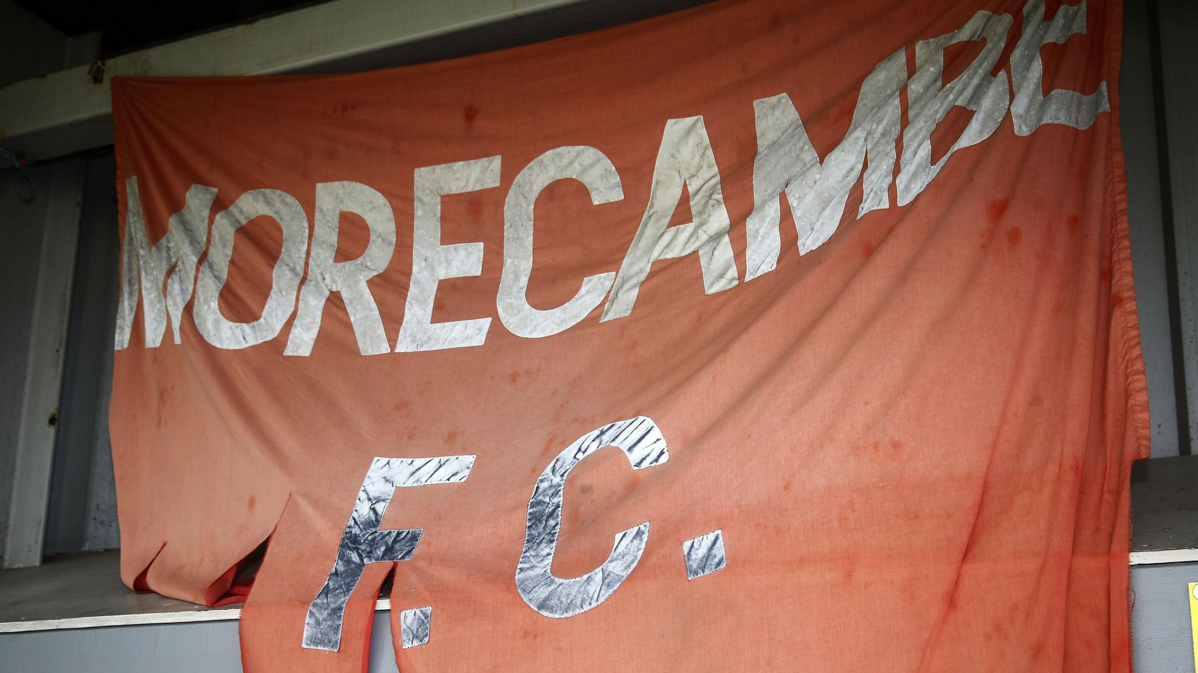 A torn Morecambe FC flag hung up at their Mazuma Stadium home