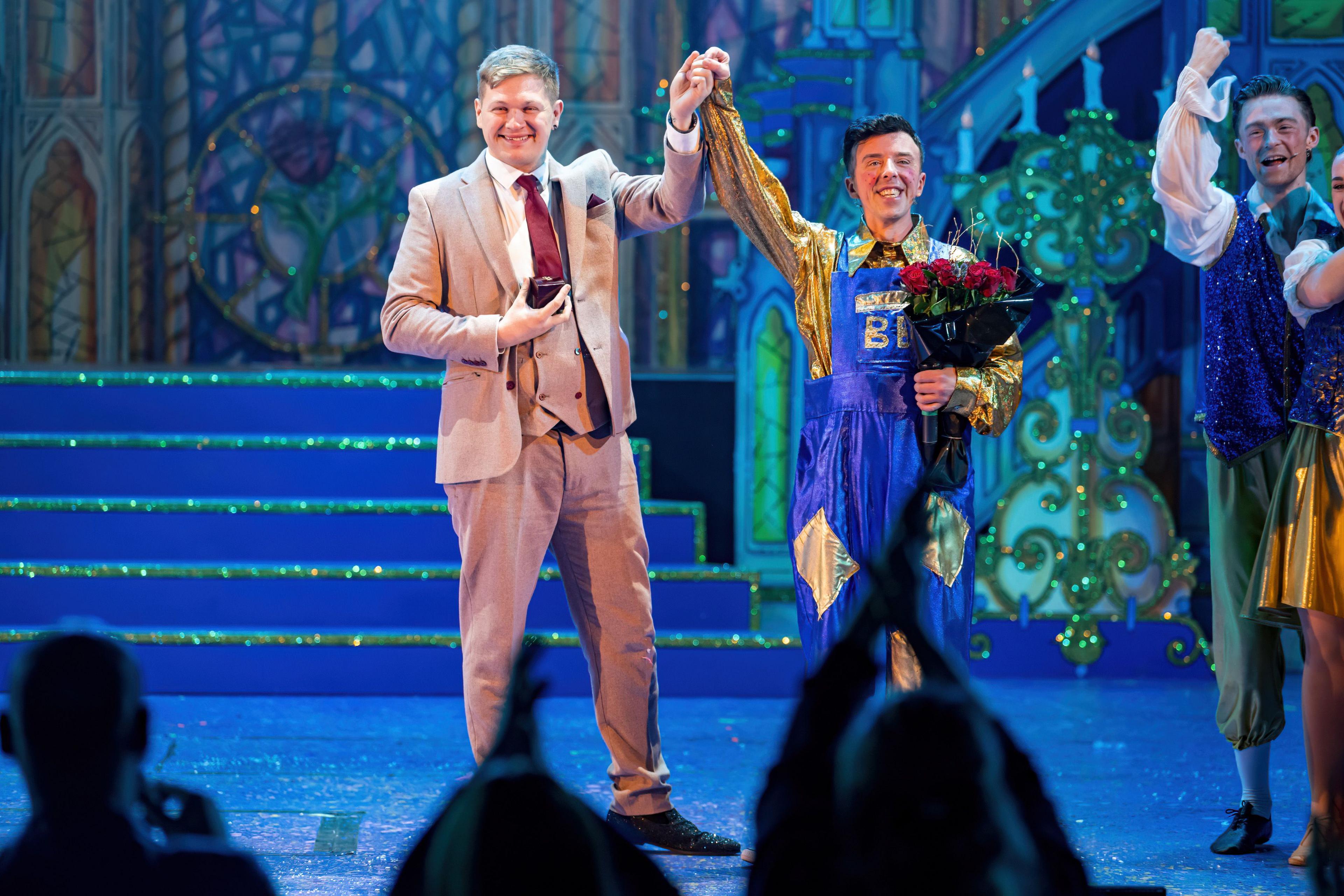 Lee Johnston and Lee Samuel raise arms and celebrate on stage