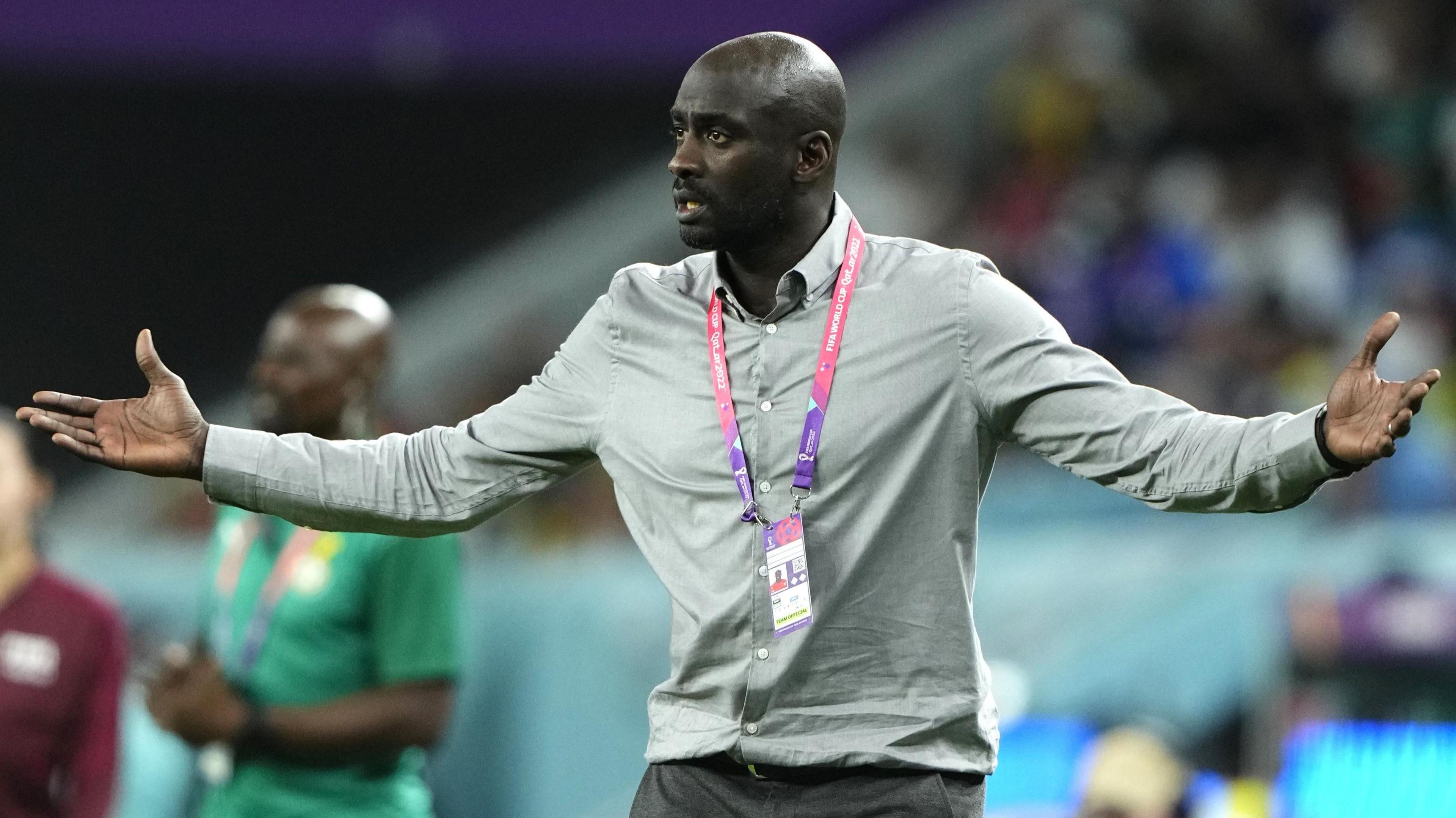 A picture of Ghana coach Otto Addo with his arms outstretched during a match at the 2022 World Cup