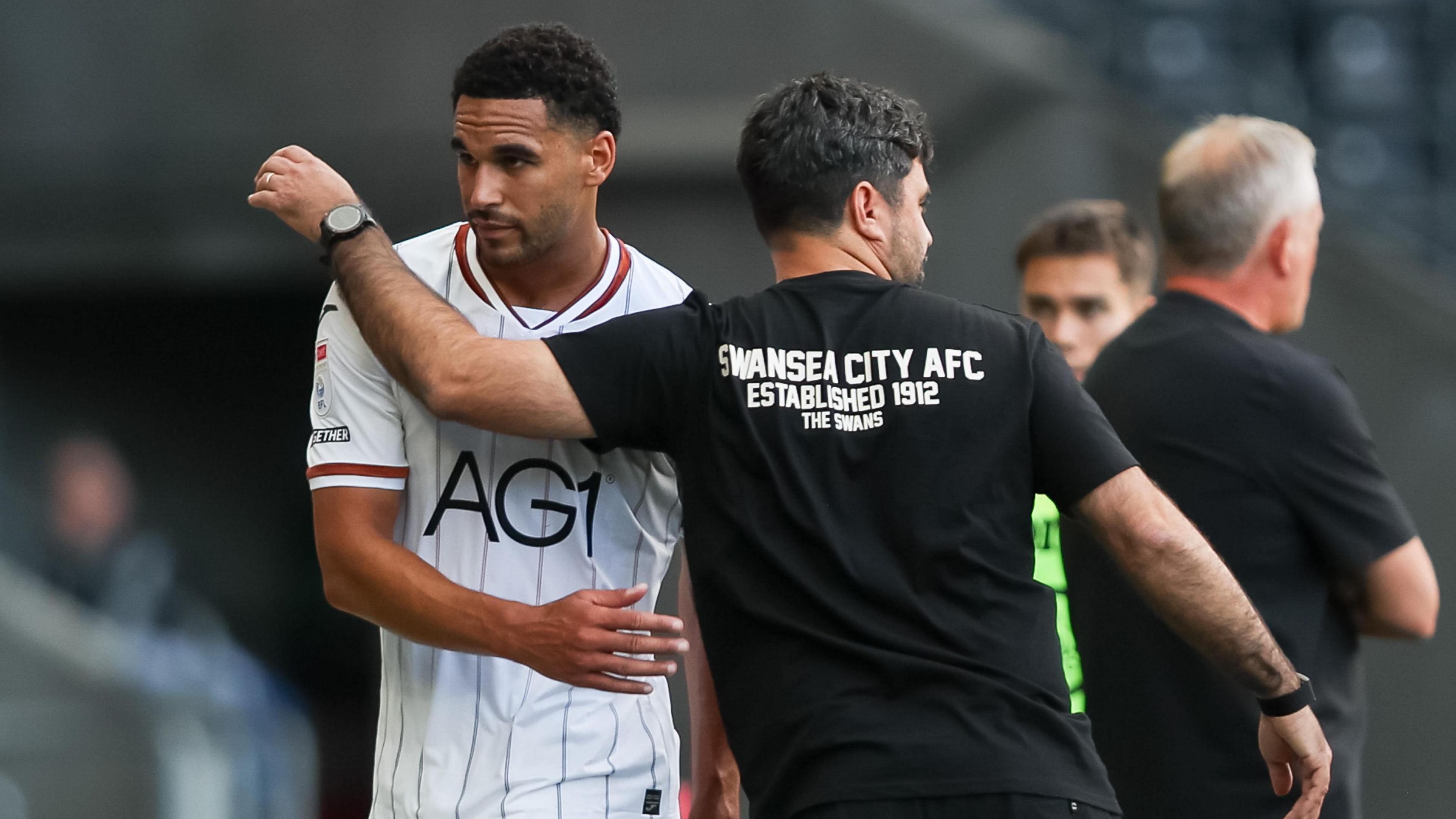 Ben Cabango and Vitor Matos on the touchline 