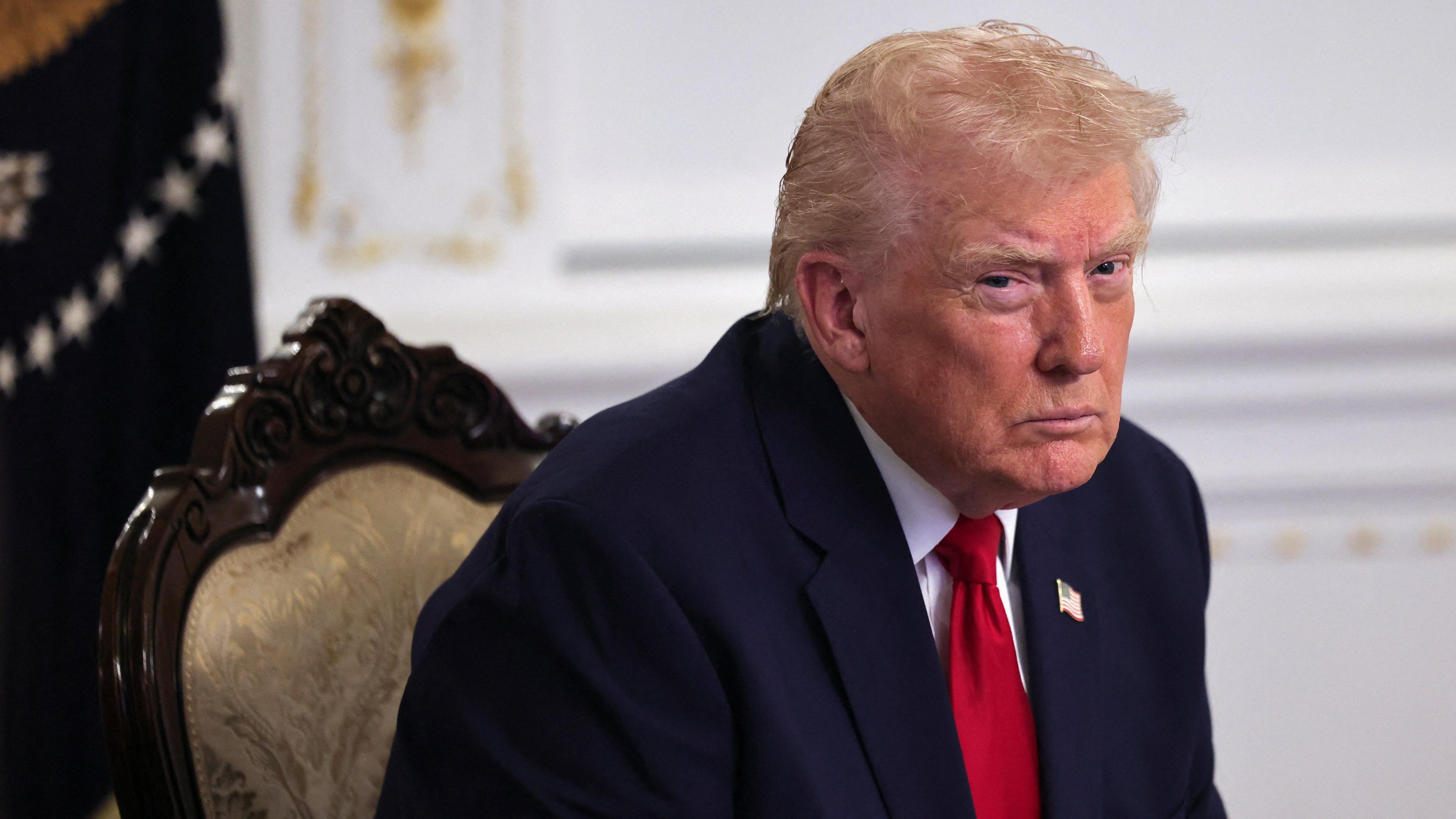 US President Donald Trump looks on as he participates in a call with service members of the US Army