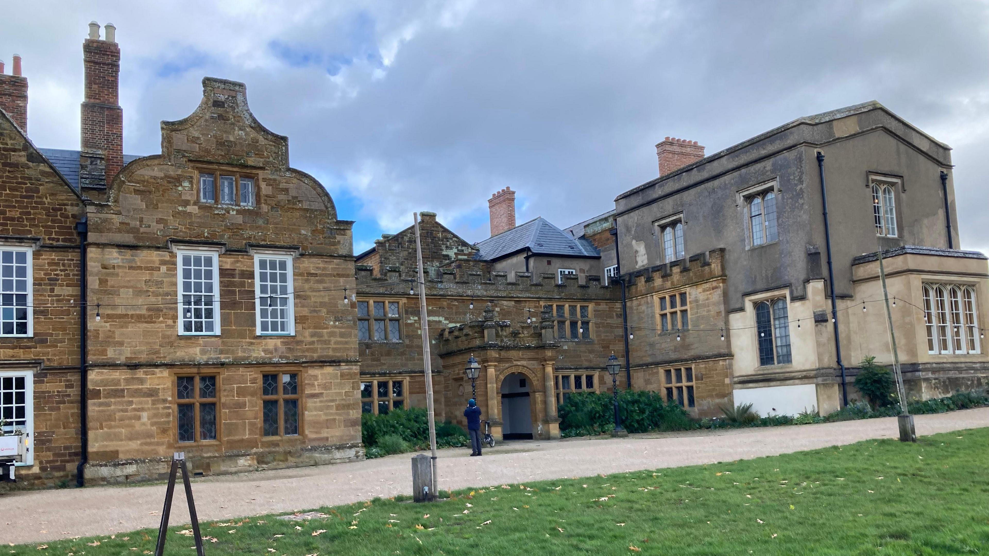 A grand looking building with arches and bay windows