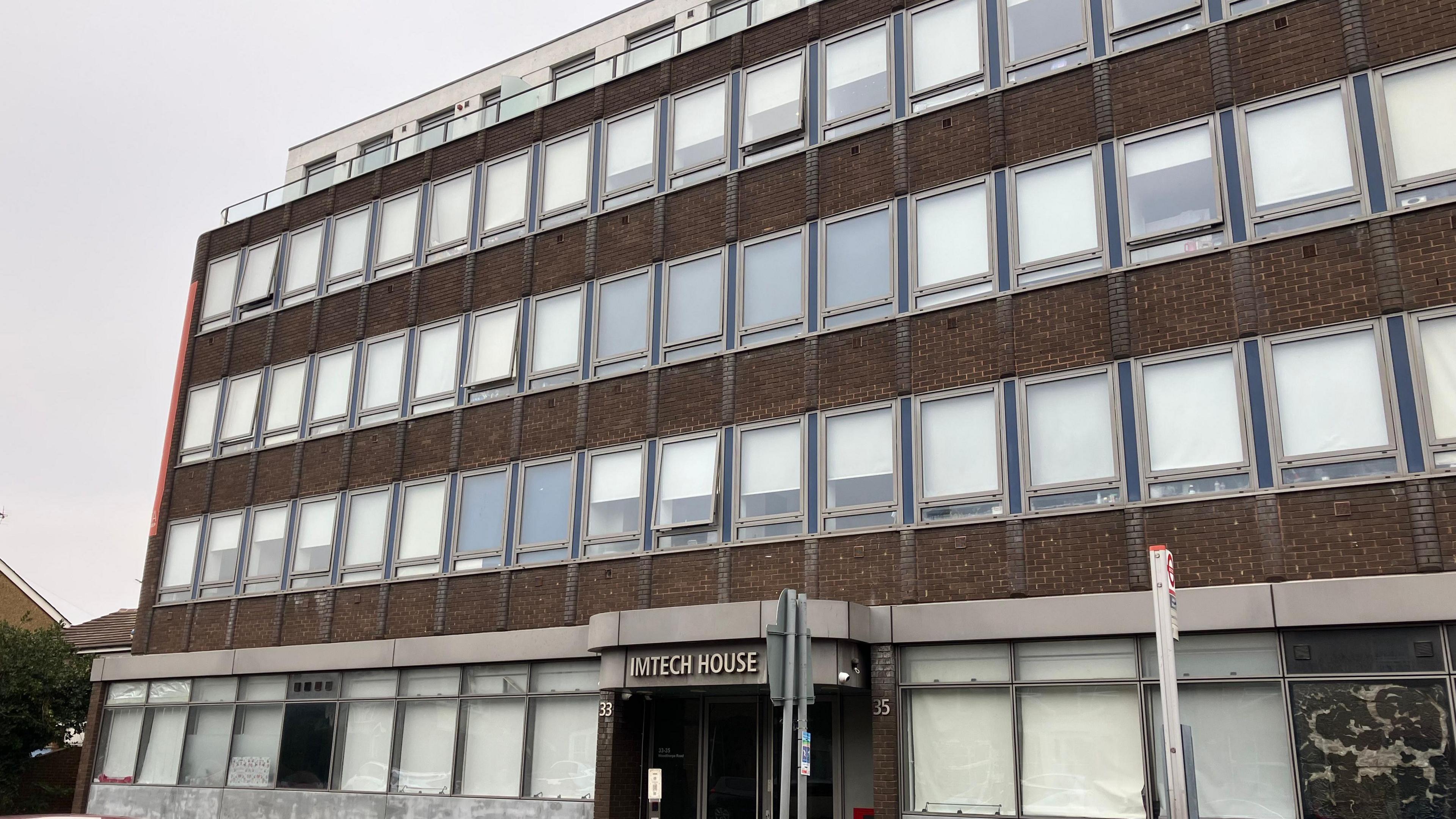 A picture of Imtech House - a block of flats with most of blinds down covering the windows