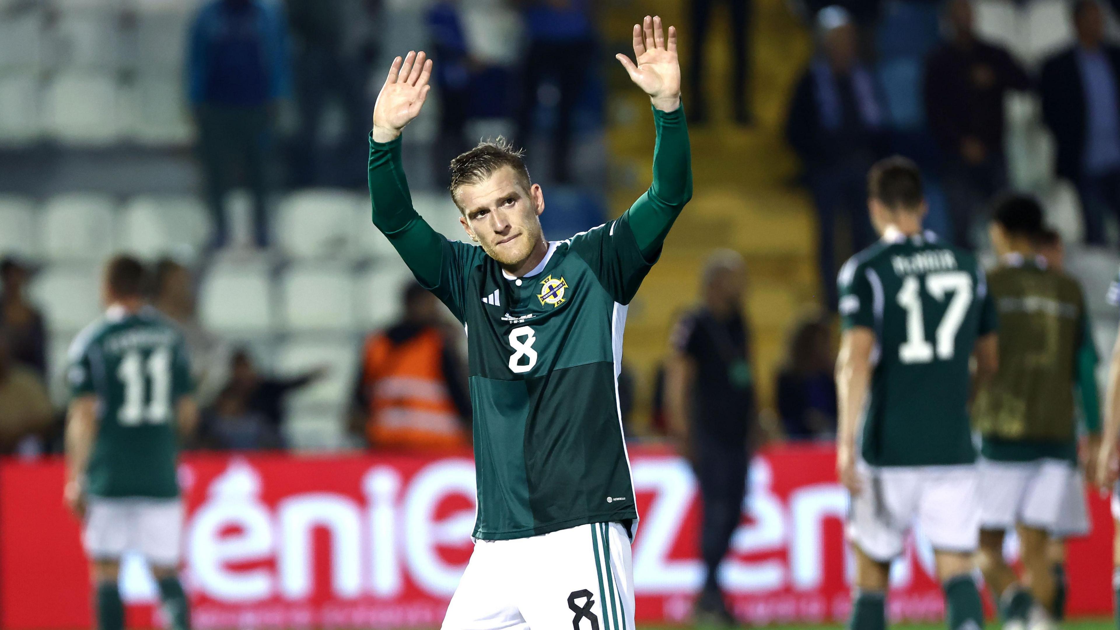 Steven Davis applauds supporters at Windsor Park