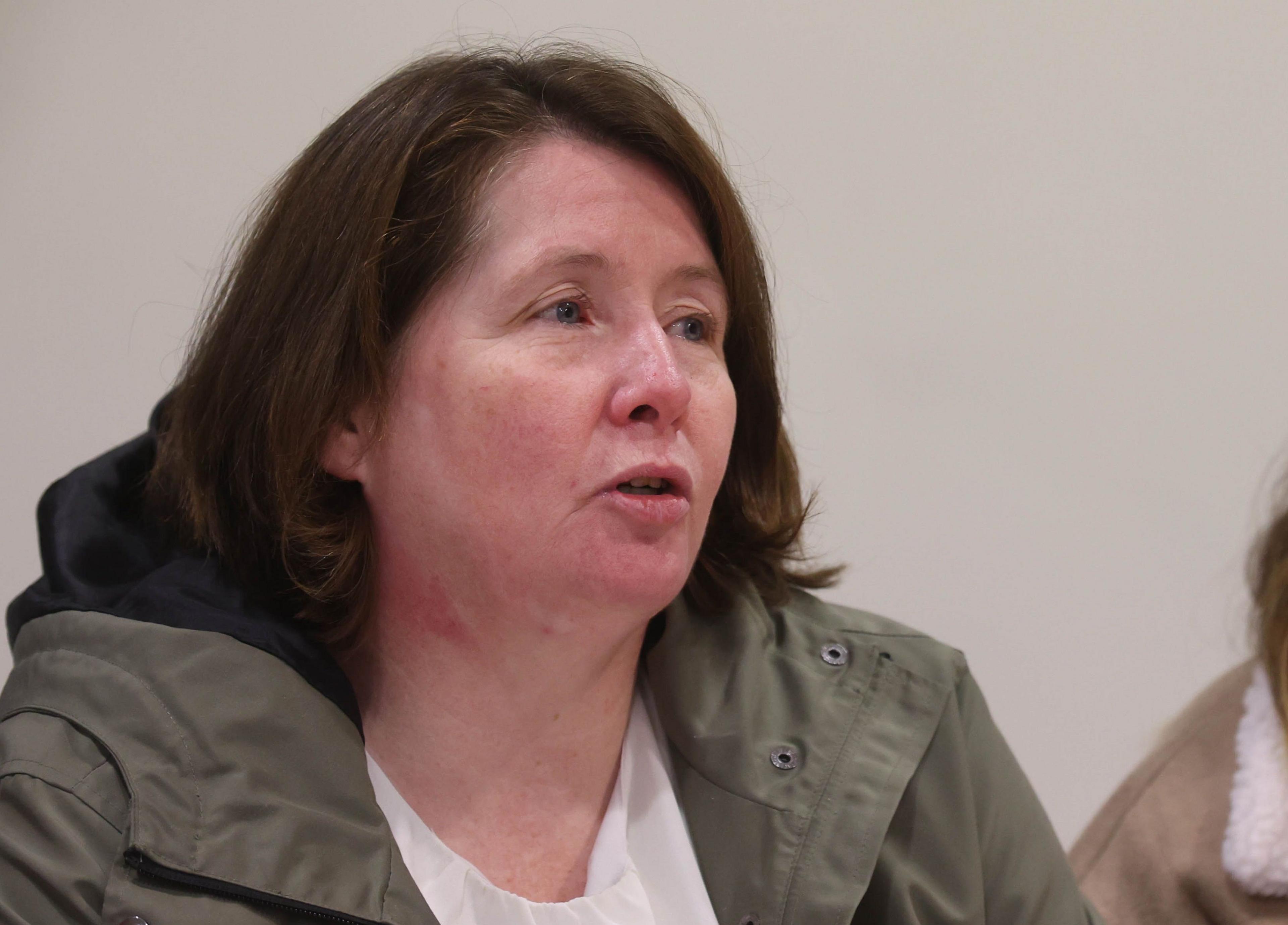 Noleen Mullan, the mother of Katie Simpson, speaking at a press conference. She is wearing an olive coat over a white top.