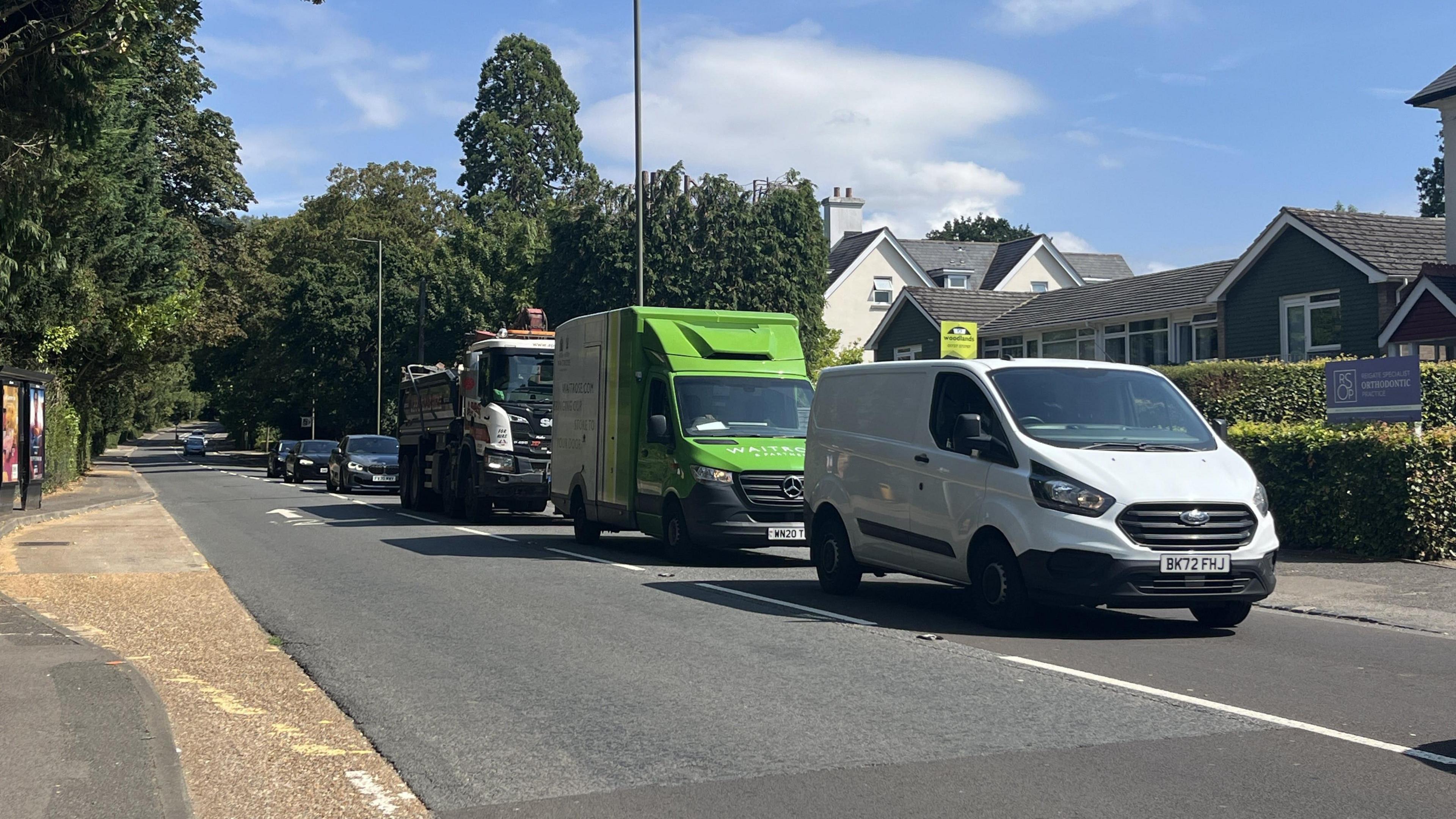 A general shot of Reigate Hill in Reigate with vans and cars in shot