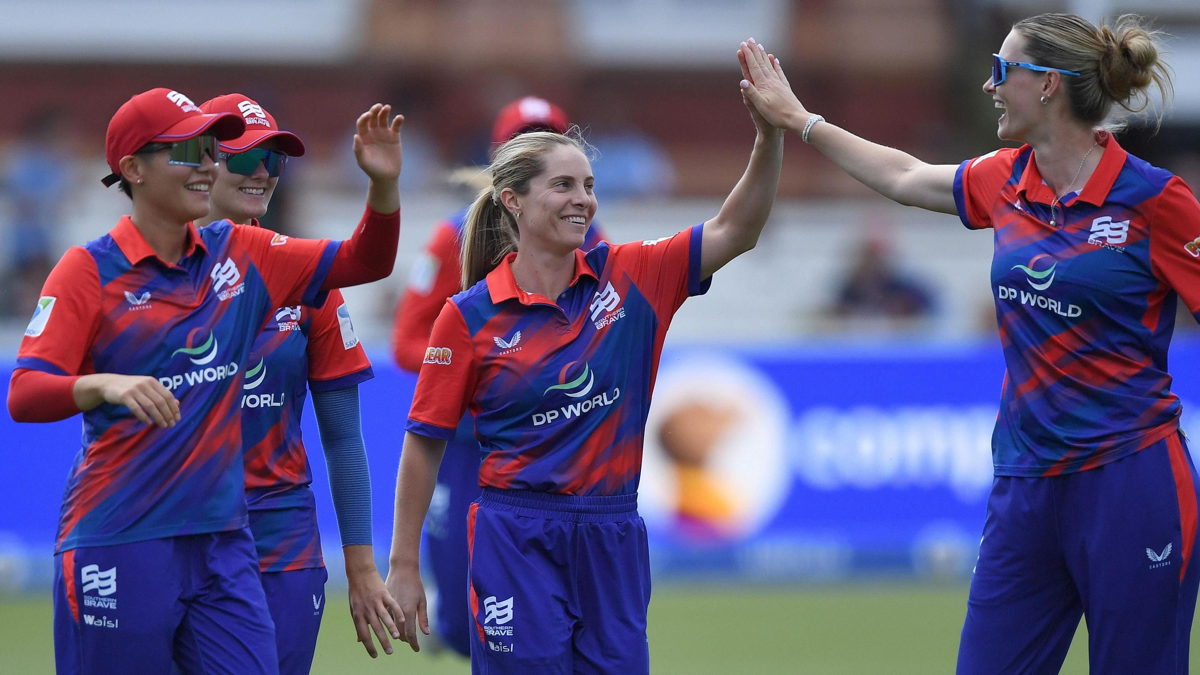 Southern Brave players Sophie Molineux, Lauren Bell and Issy Wong celebrate a wicket
