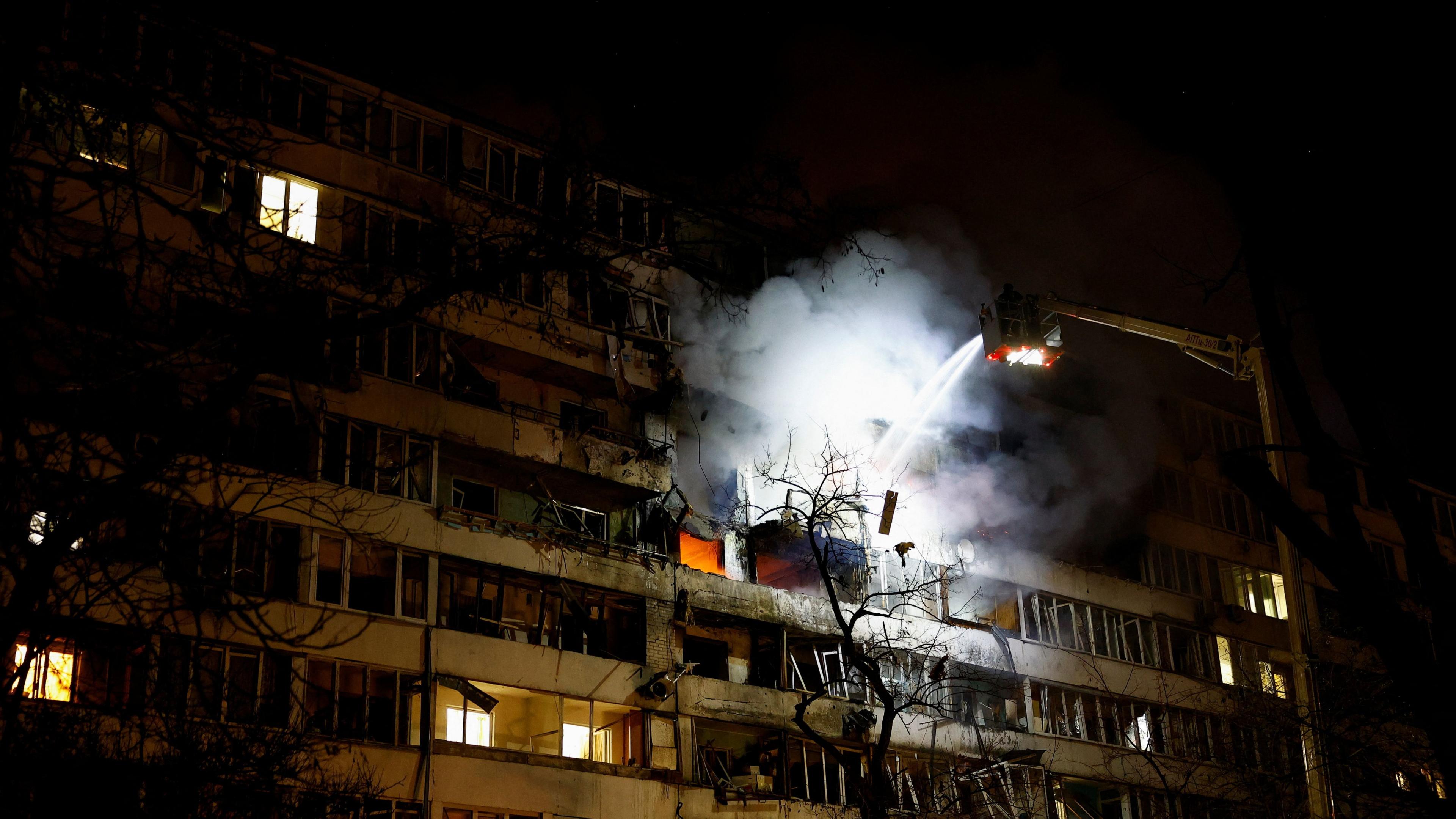 A firefighter works at the site of an apartment building hit by a Russian drone strike in Kyiv, Ukraine on 25 November 2025.