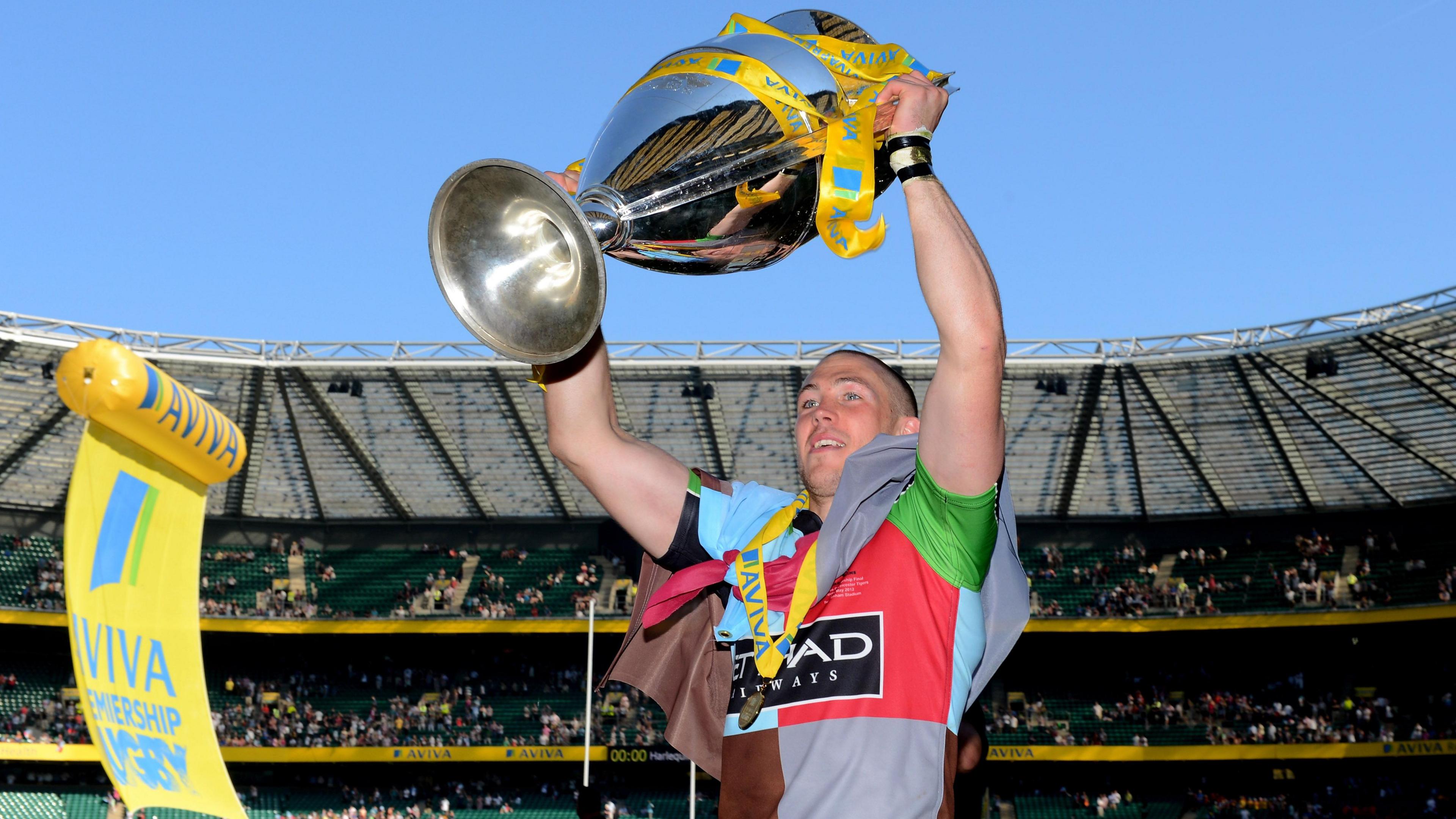 Mike Brown holds up the Premiership trophy as a Harlequins player