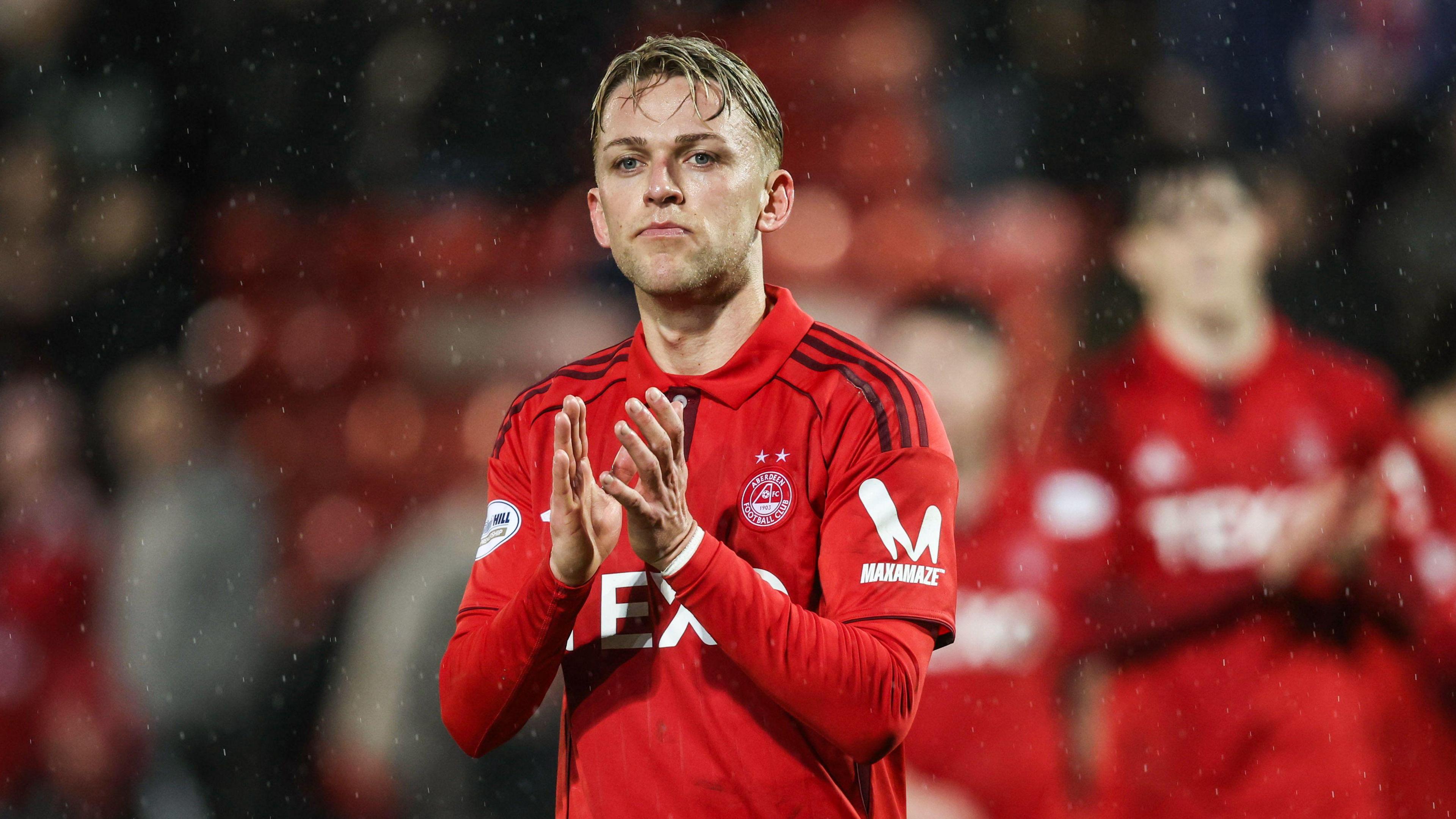 Jesper Karlsson applauds Aberdeen supporters