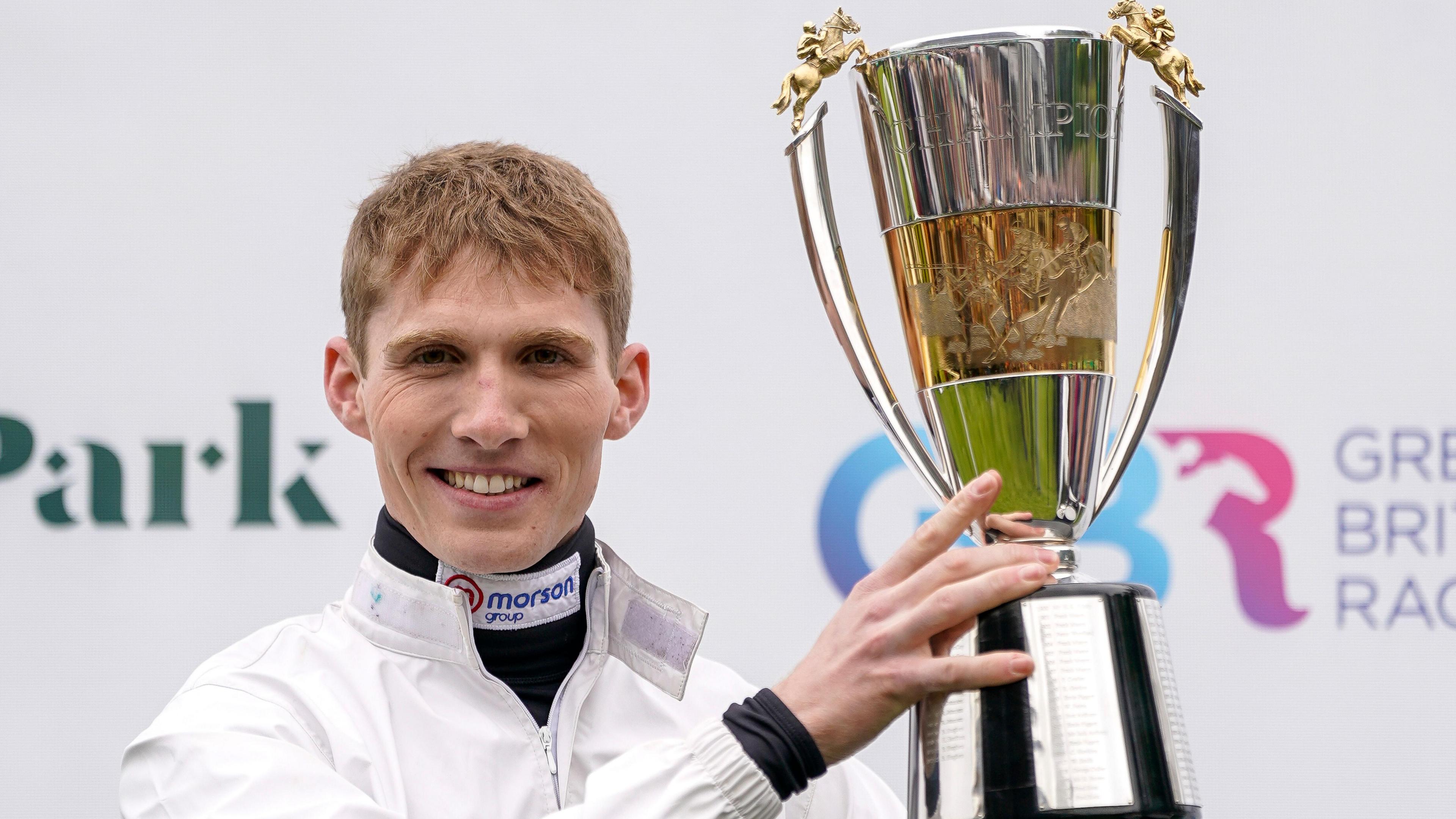 Harry Cobden holds up his trophy