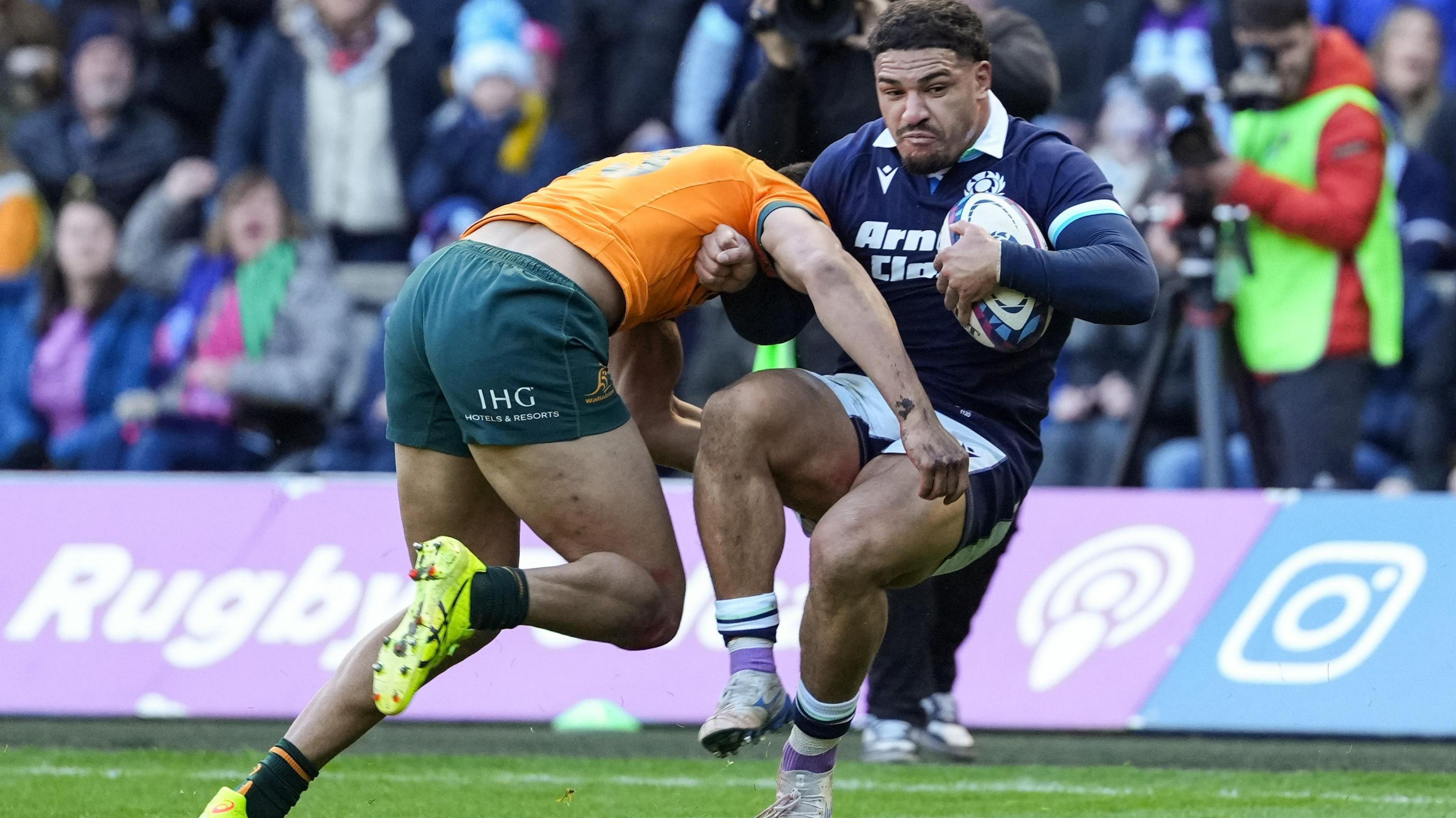 Joseph Suaalii slams into Scotland's Sione Tuipulotu sending him backwards