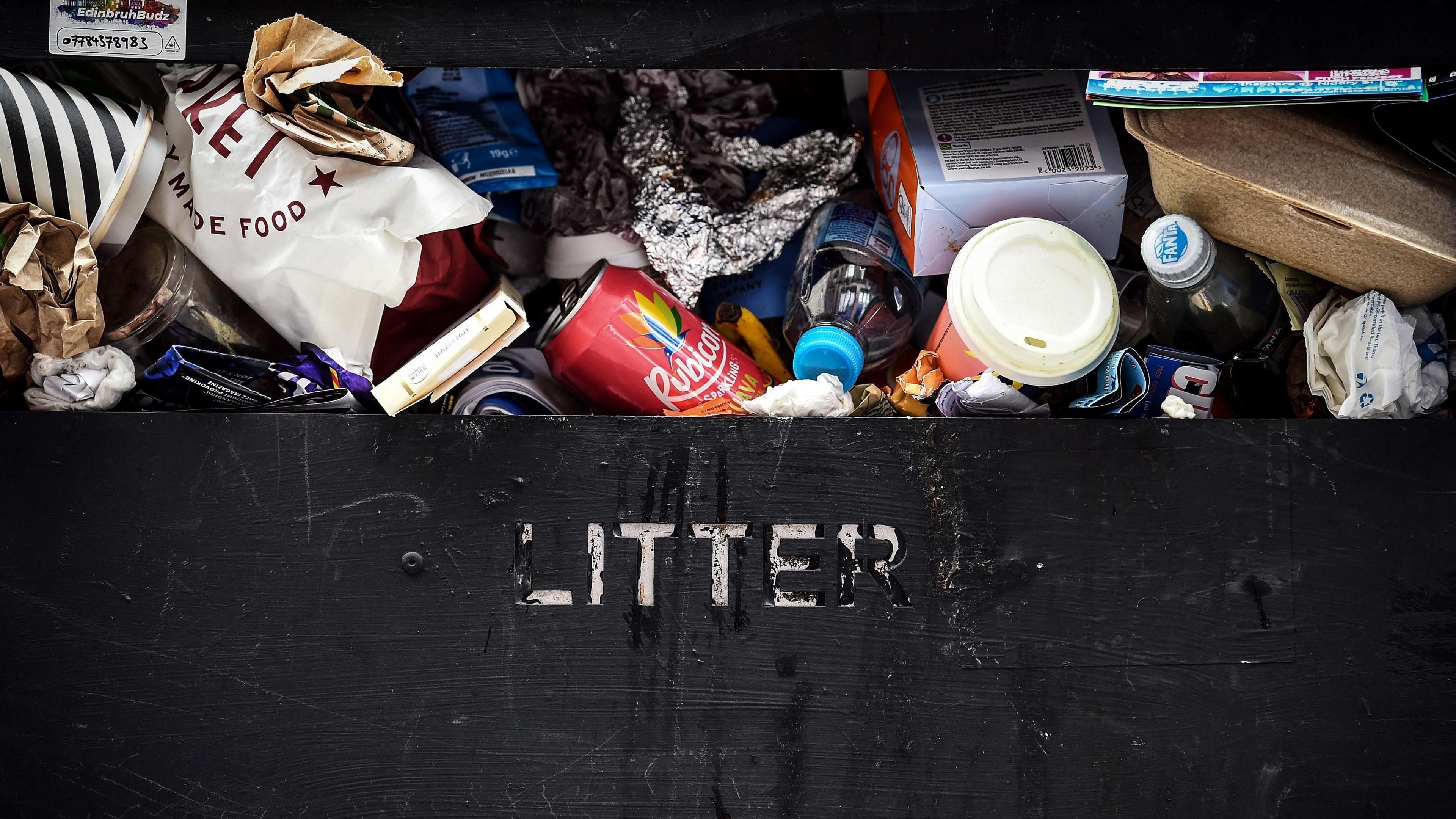 An overflowing rubbish bin