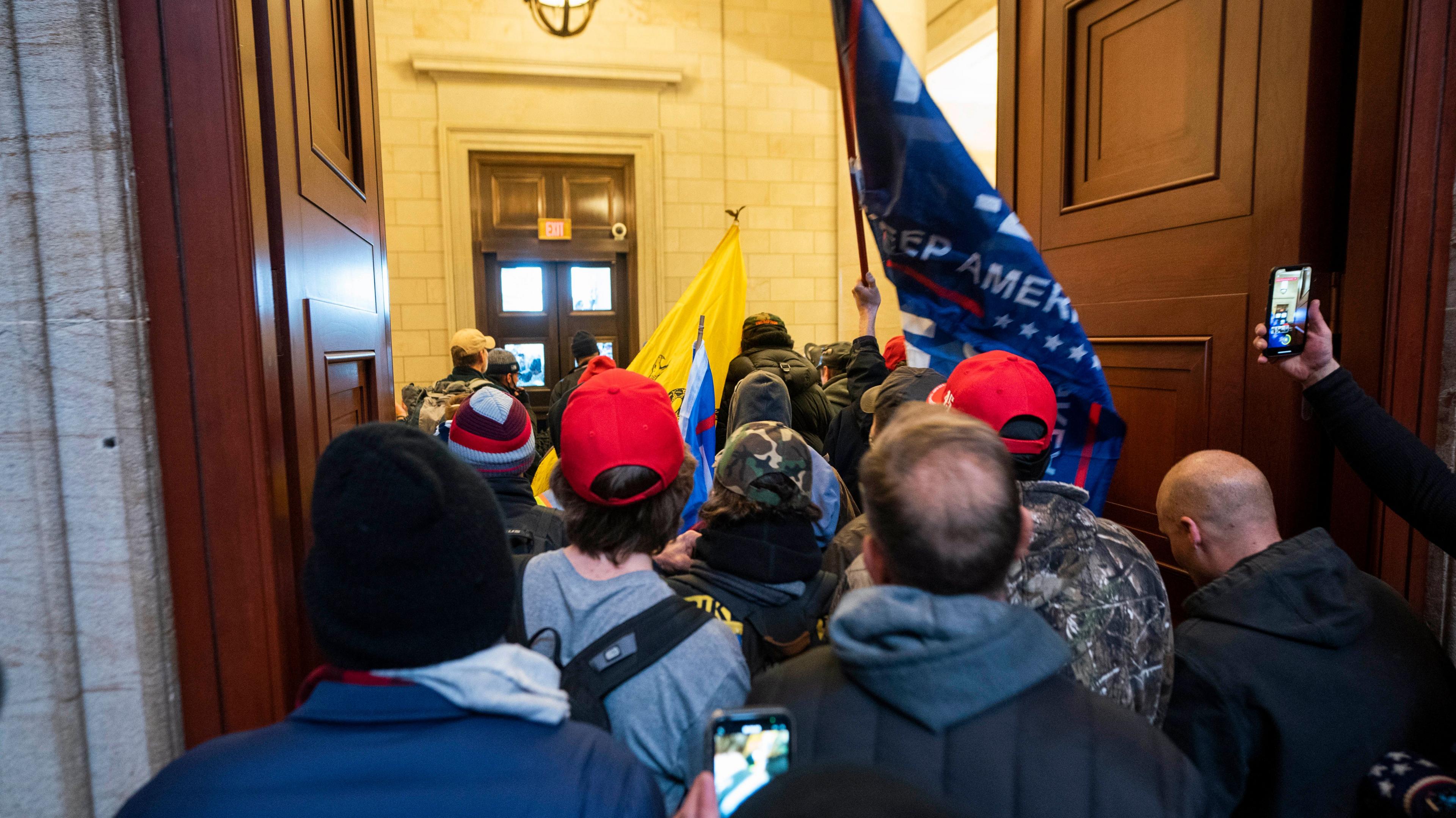 supporters of US President Trump stand by the door of the Eastern front after they breached the US Capitol security in Washington, DC, USA, 06 January 2021