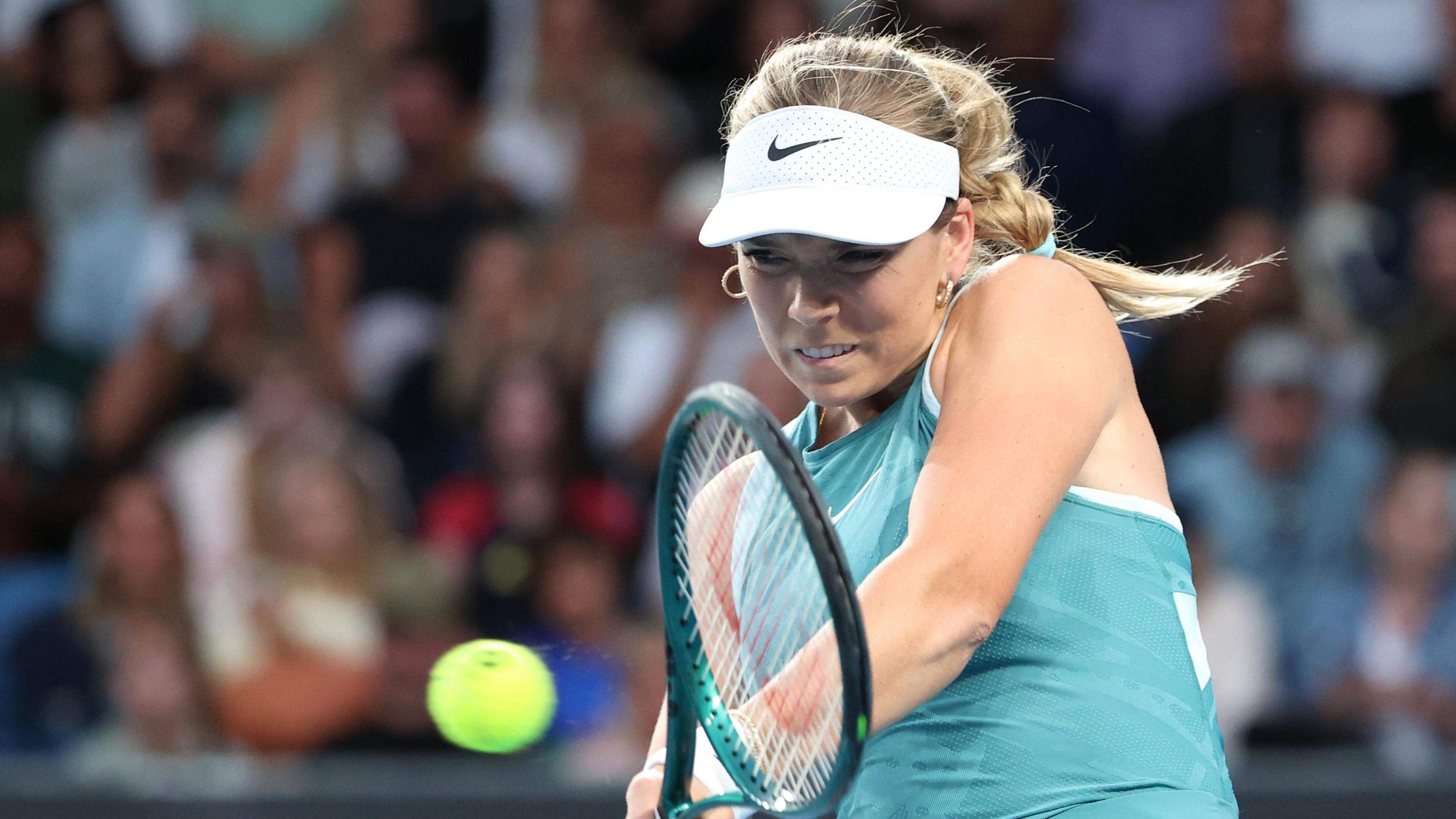 Katie Boulter hits a return at the Australian Open