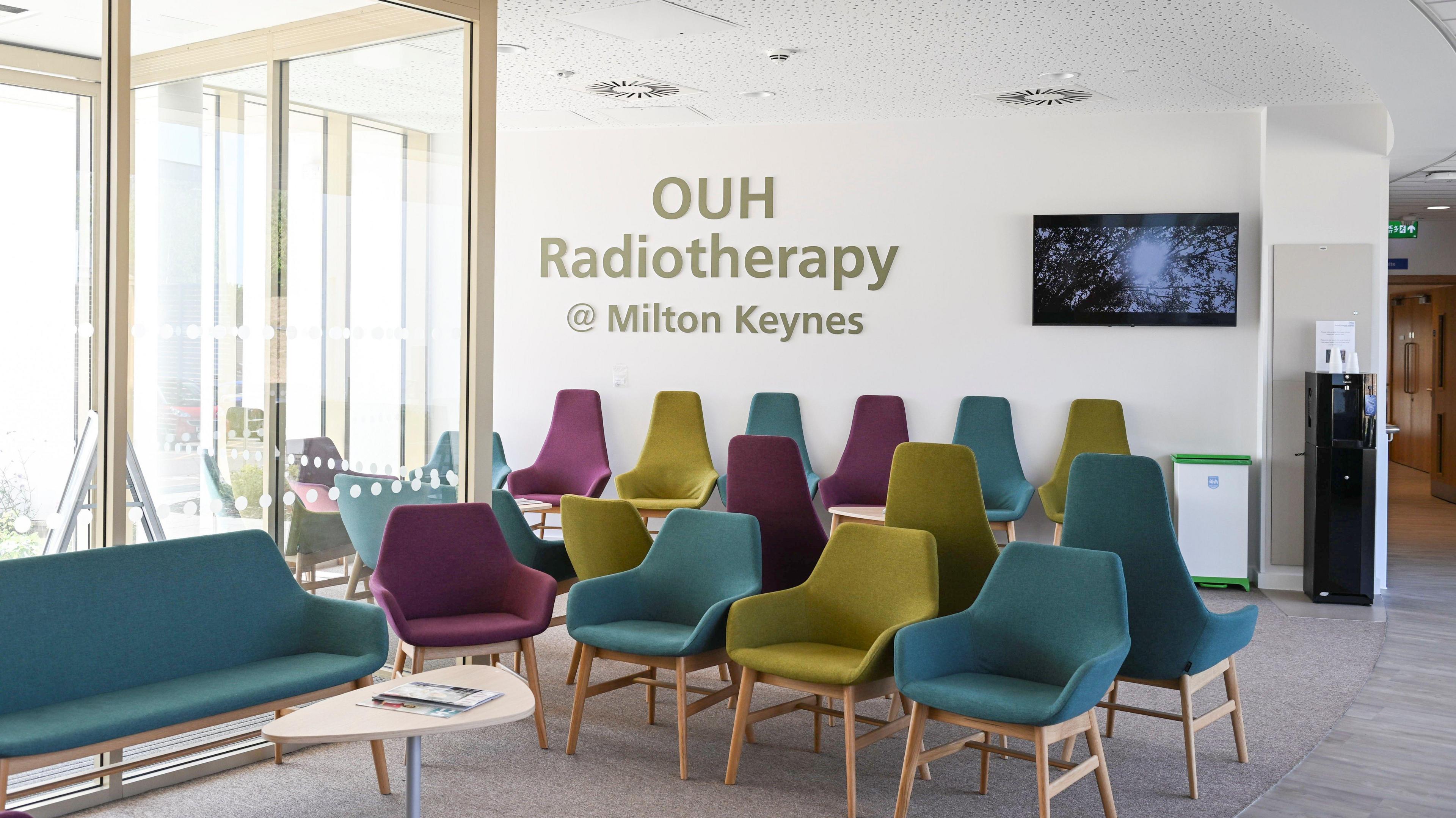 A medium shot of the waiting area at OUH Radiotherapy @ Milton Keynes with colour, comfortable seats.