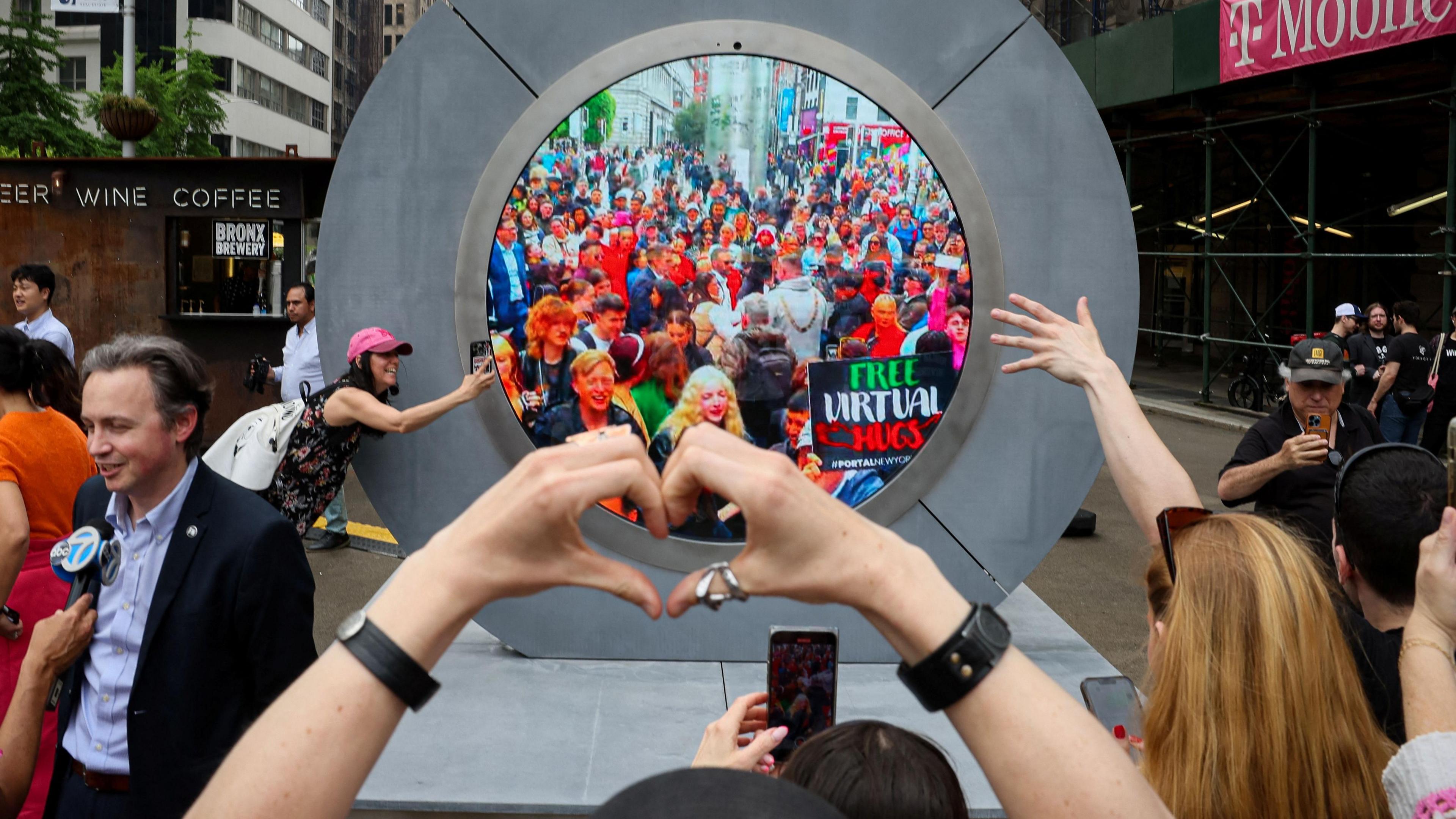 people in Dublin and New York wave to each other through the portal