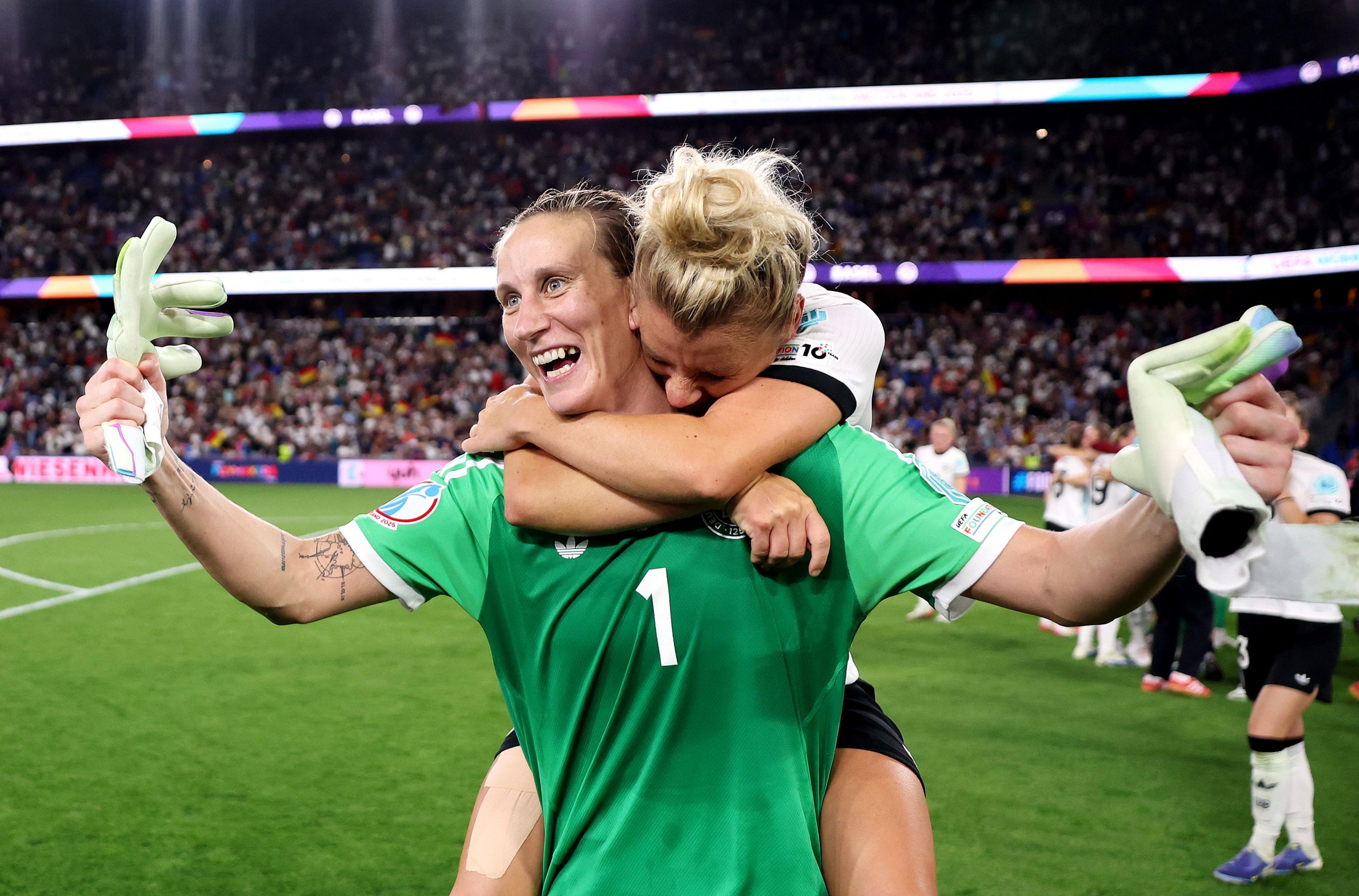 Germany's Ann-Katrin Berger celebrates victory with teammate Linda Dallmann after defeating France 6-5 in the penalty shootout during the UEFA Women's EURO 2025 Quarter-Final in Basel, Switzerland. Photo by Maja Hitij