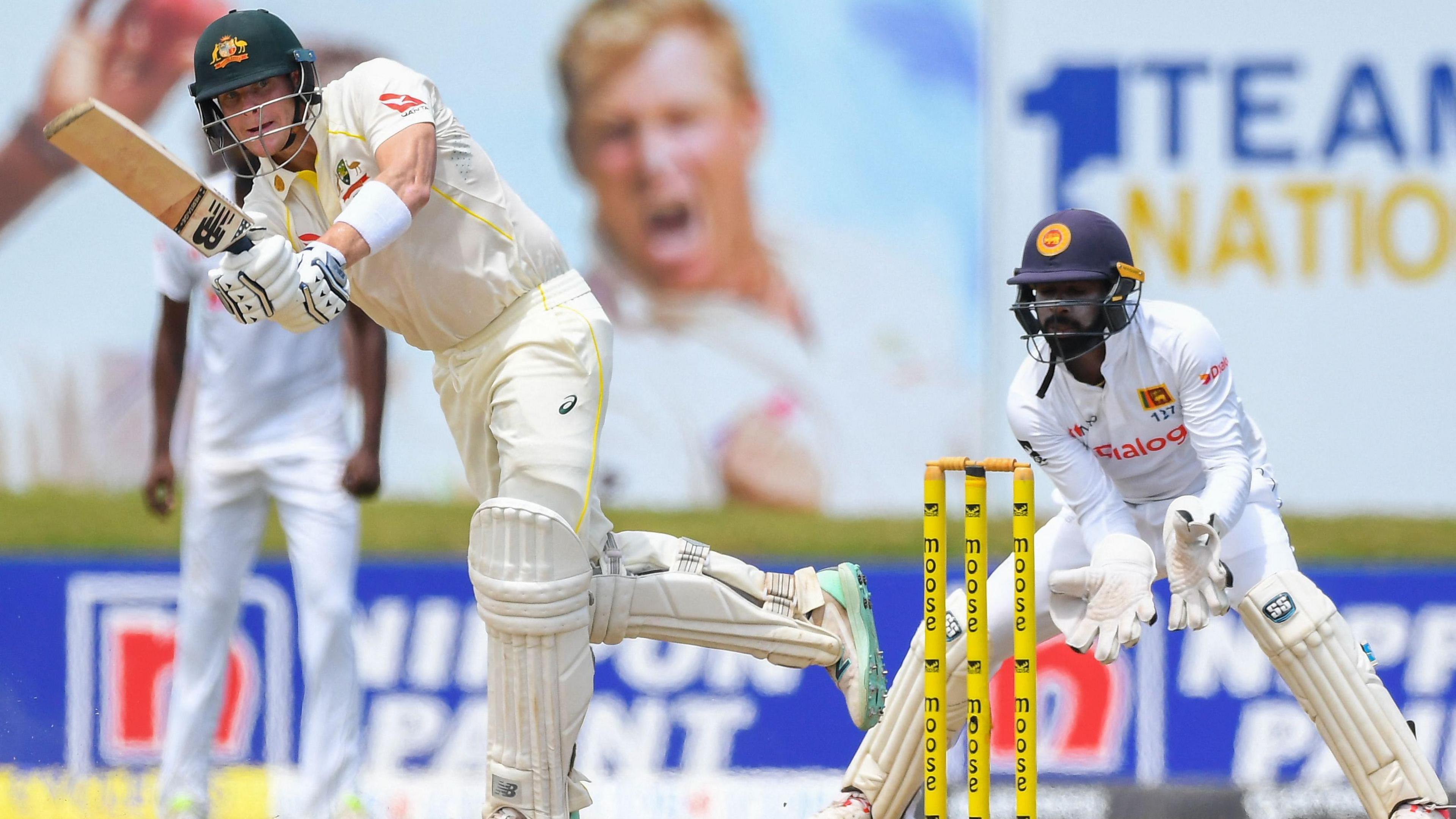 Australia's Steve Smith plays a shot as Sri Lanka's wicketkeeper Niroshan Dickwella (R) watches during the second day of second cricket Test match between Sri Lanka and Australia at the Galle International Cricket Stadium