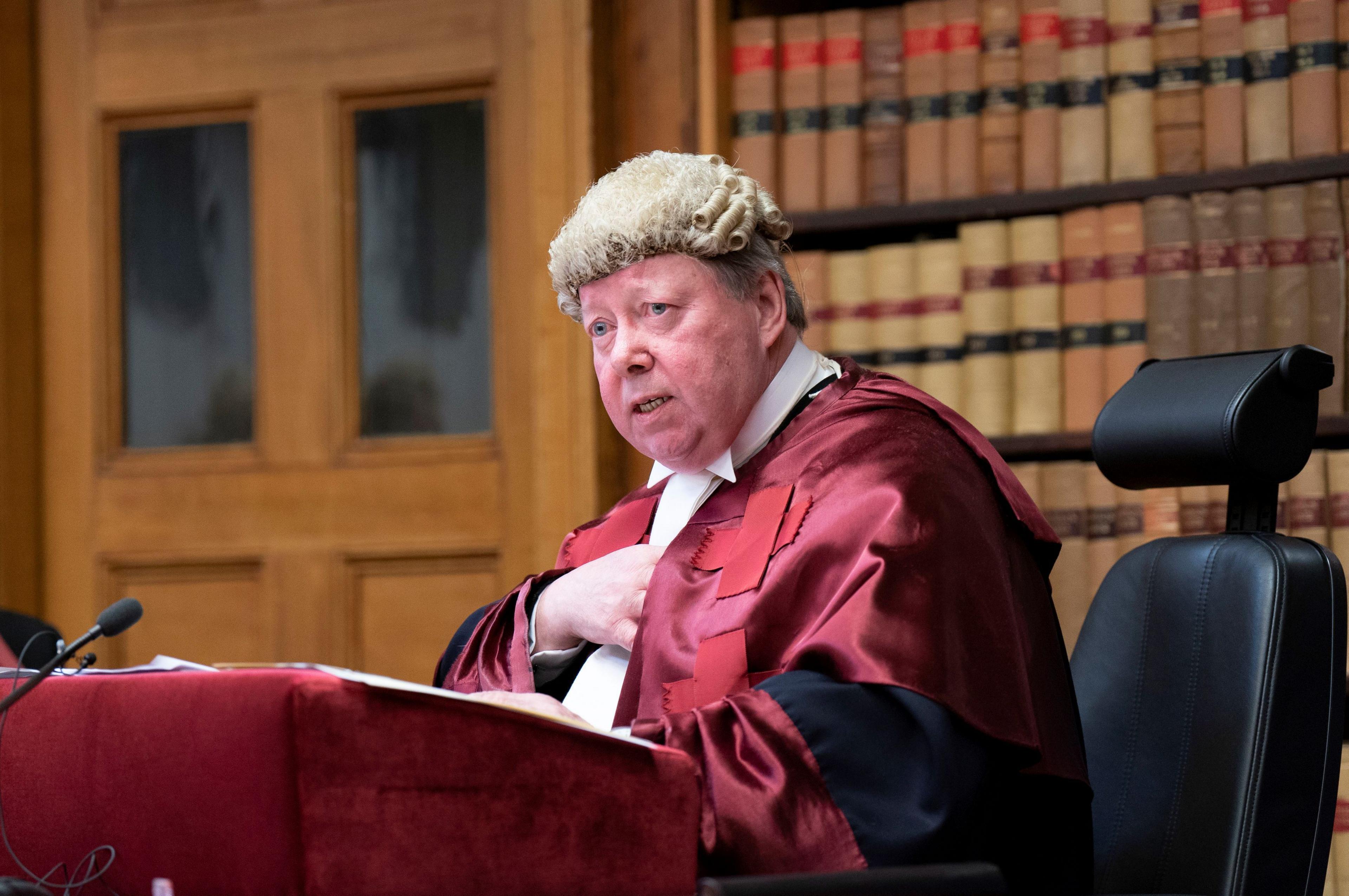 Judge Lord Carloway in a court room wearing. He is sitting at a lectern wearing his wig and gown.