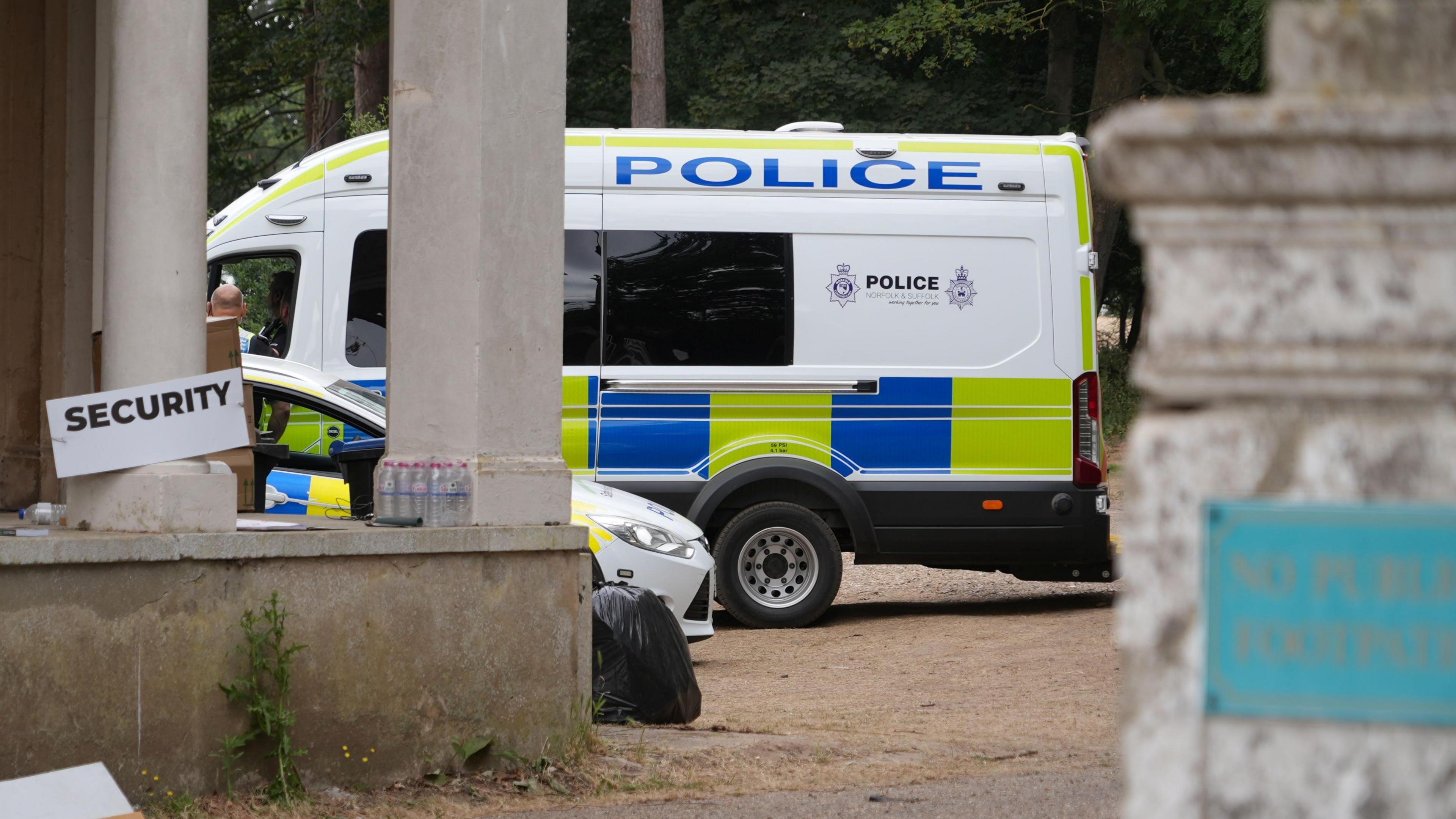 A police van and a police car parked next to each other.