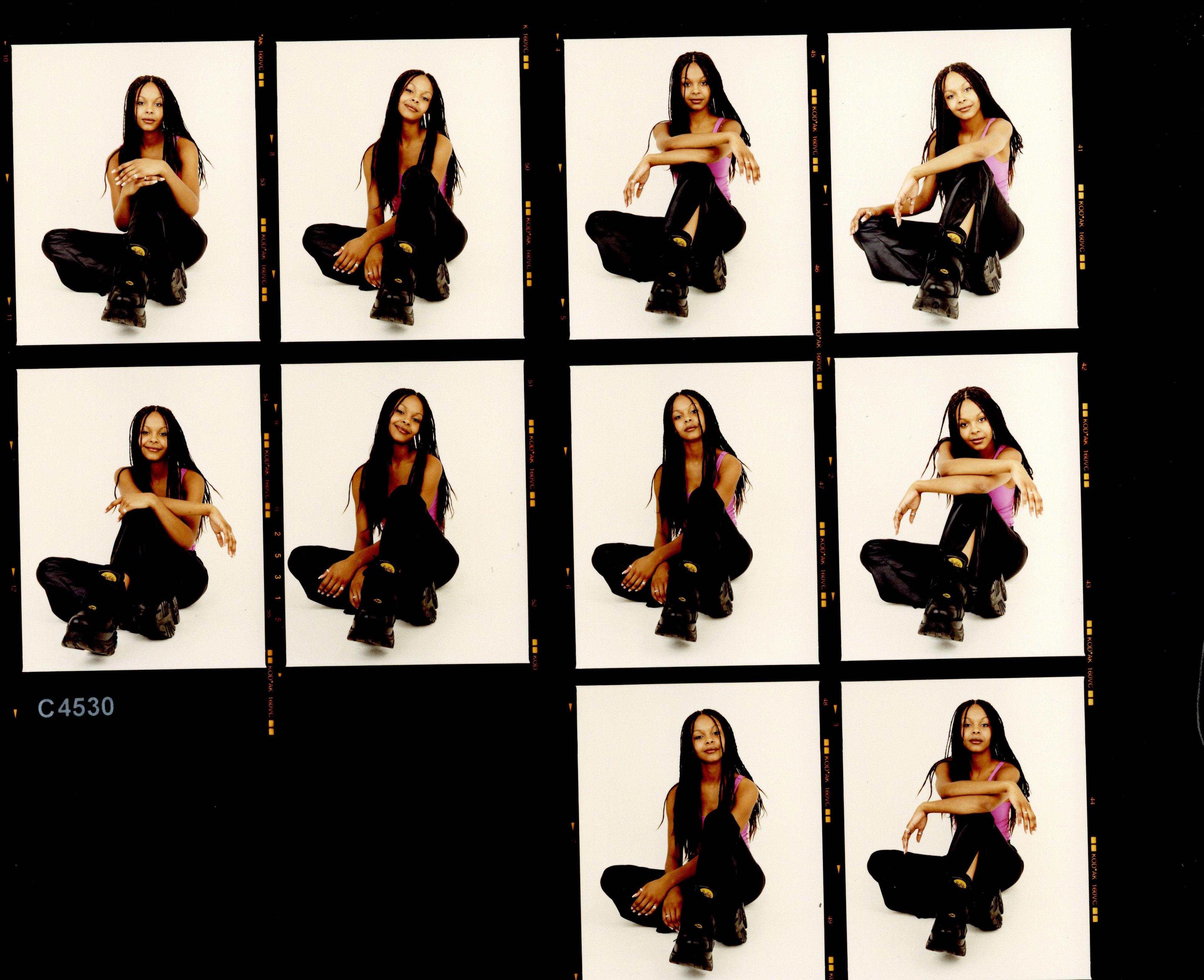 Contact sheet of multiple film photographs of a young girl with long, braided hair. Wearing a pink top and black trousers, posing in a squatted, cross legged position
"Samantha Mumba, Press Images, 2000, (c)Rankin"