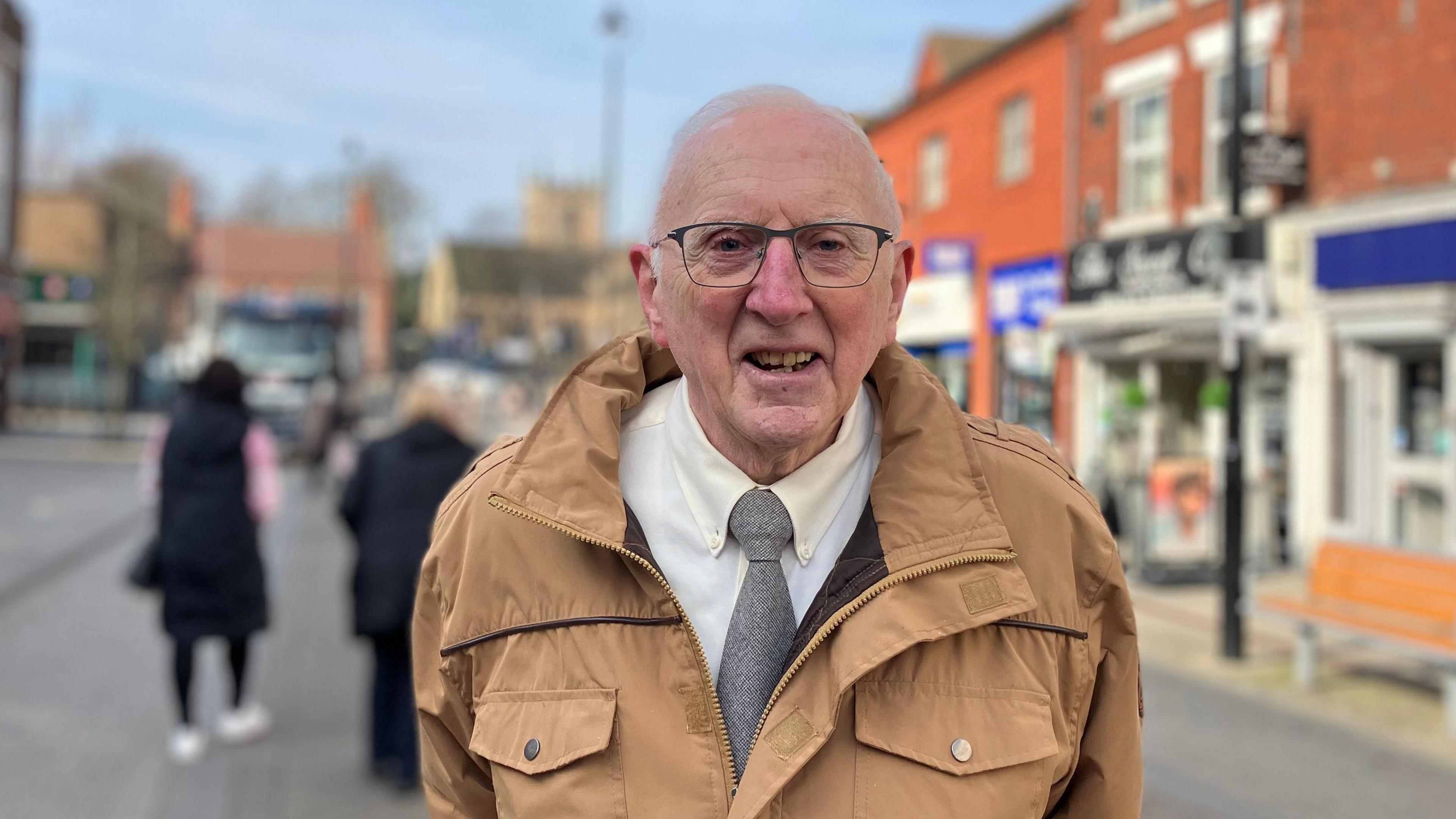 Tony Bucknall, stood on Hucknall High Street, looking at the camera