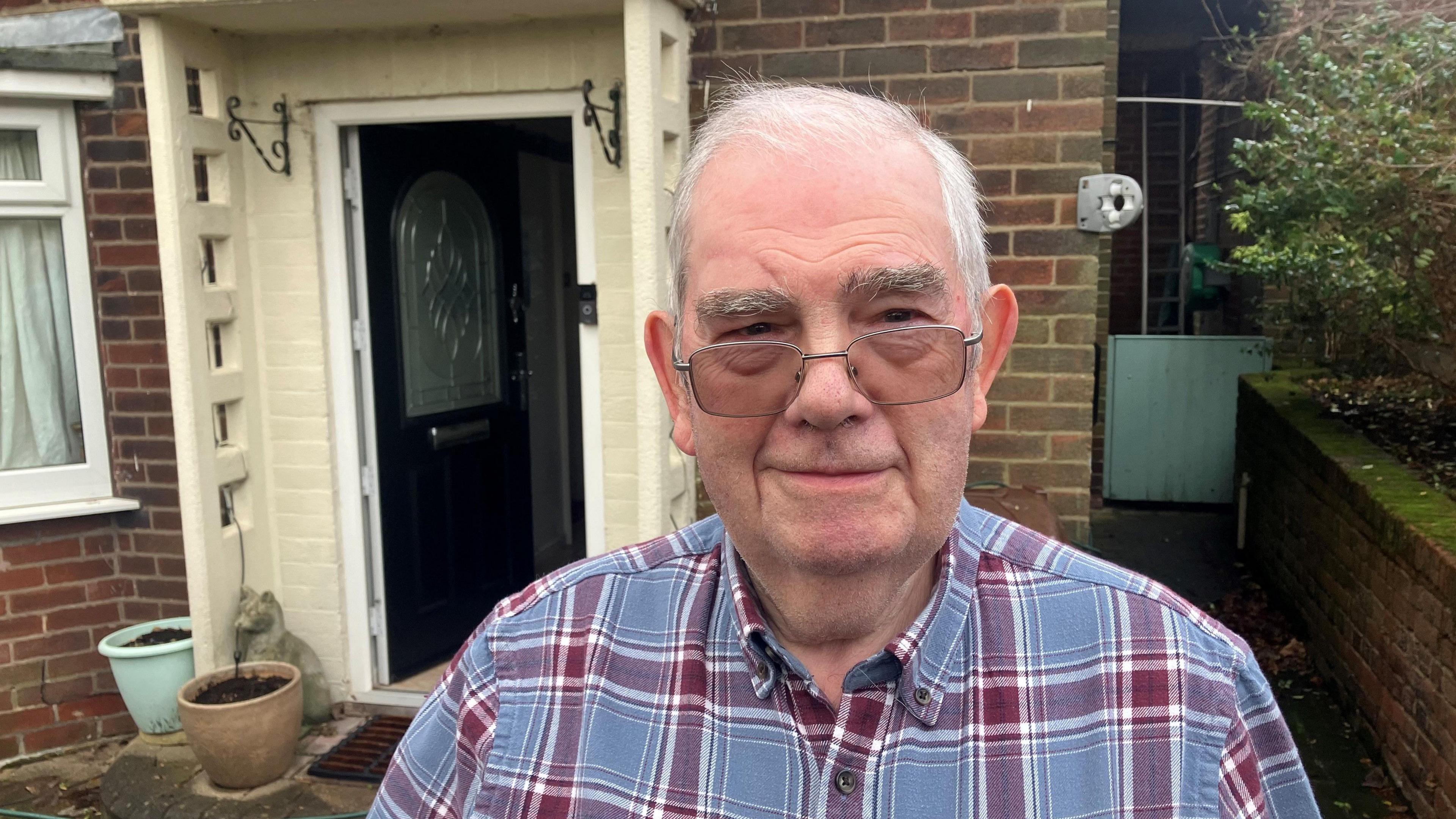 Photograph of Brian Bardsley outside his home in Millbrook