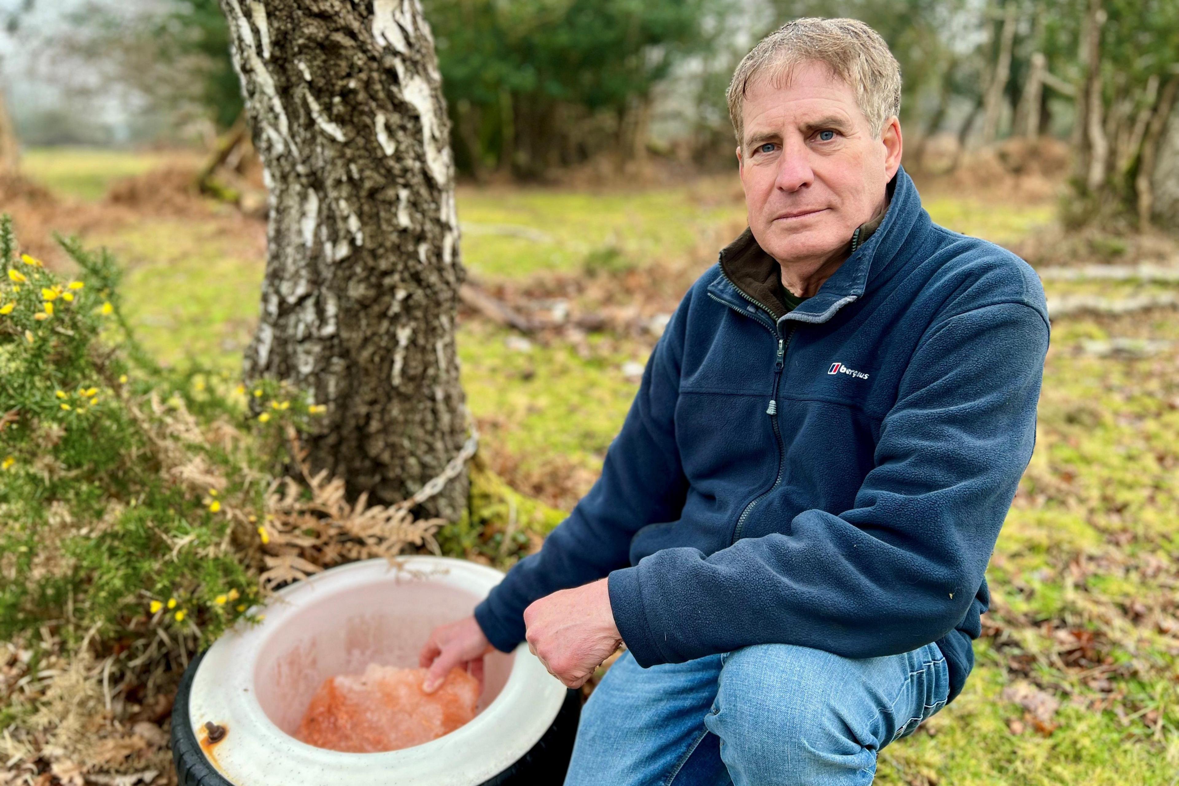 Tony Vanderhoek, a man with grey hair wearing blue jeans and a navy fleece.