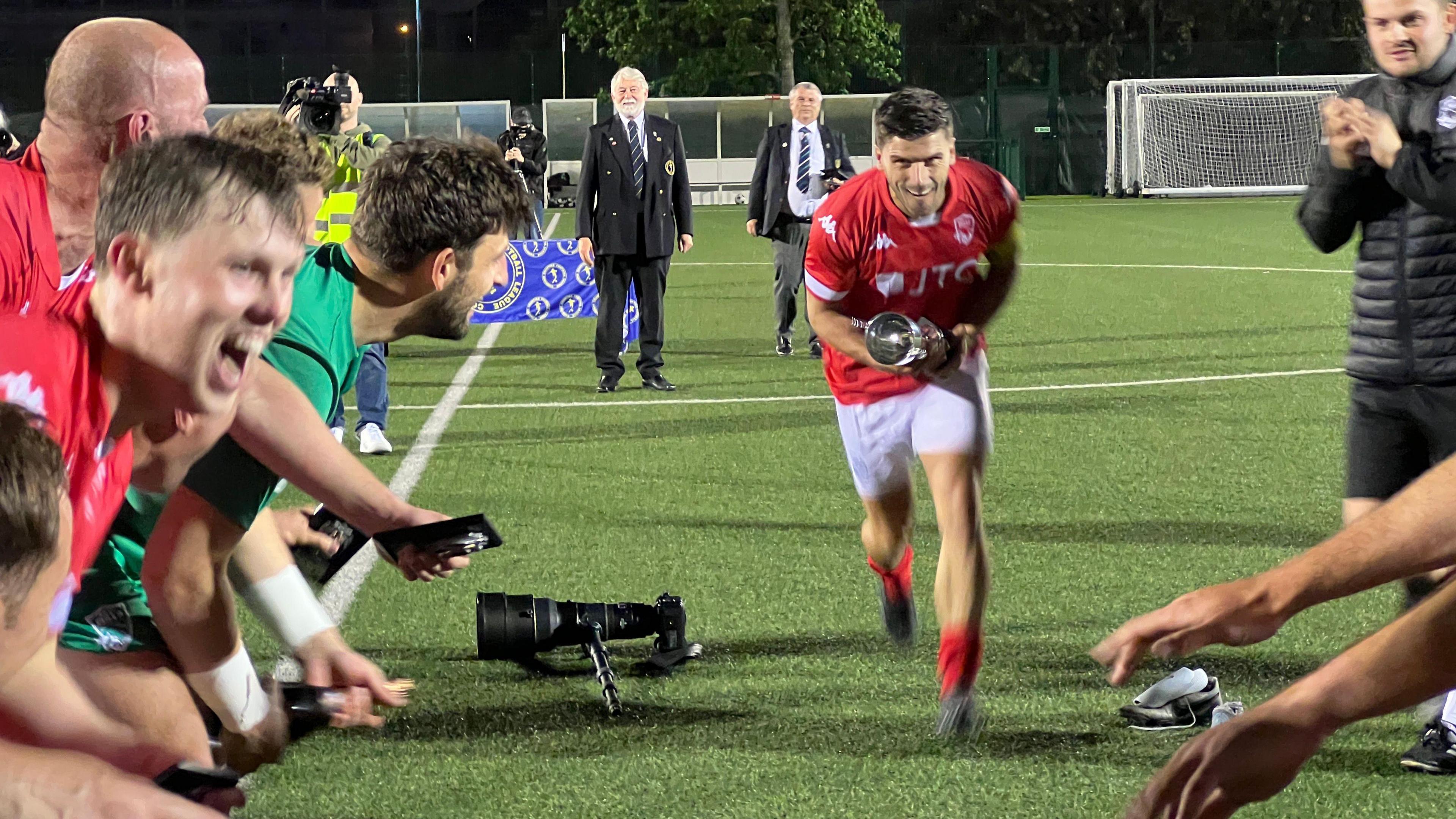 James Queree lifts the trophy after Jersey Bulls' play-off win