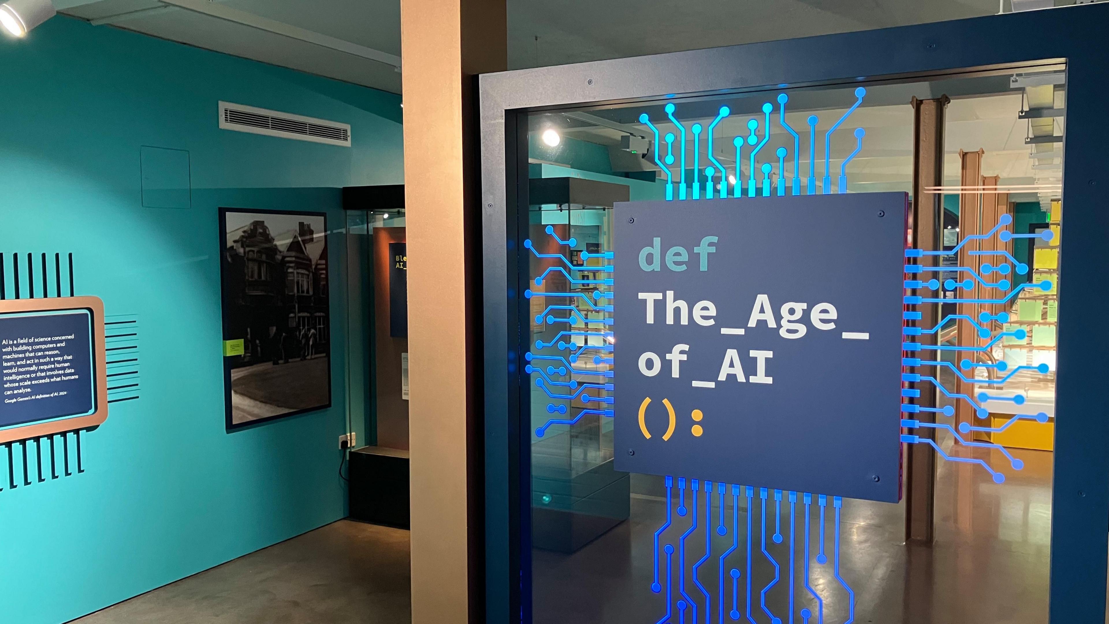 The entrance of the Artificial Intelligence AI exhibition where the title of the exhibition is displayed to look like a blue computer chip.